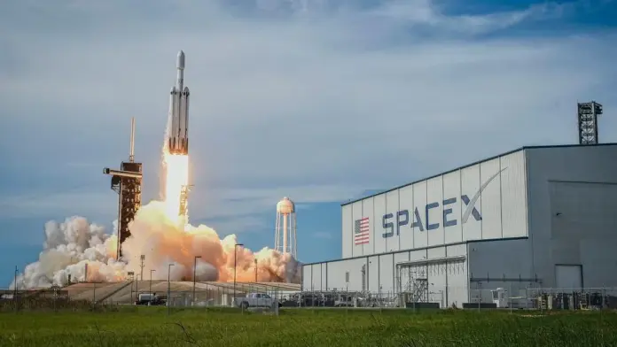 Start by killing the number that has been circulating since Tuesday evening: SpaceX did not grow profits by 92%. <strong>Revenue</strong> grew 92%, to $7.81 billion. The company still lost money — a net loss of $541 million, per the results filed with the SEC on 4 August 2026. Adjusted EBITDA nearly tripled to $3.54 billion, revenue beat the FactSet consensus of roughly $6.9 billion by almost a billion dollars, and Starlink subscribers doubled to 12 million. And SPCX still fell 7.6% in after-hours trading, extending to a 10.9% decline by Wednesday's pre-market at $111.70. The reason sits in one line of the release: capital expenditure of $18.37 billion for a single quarter, against $10.11 billion in the prior quarter. SpaceX spent 2.4 times its revenue building things. That is the whole story, and it is neither a growth story nor a profit story. It is a timing story.
Here is the framing that the coverage has missed. The question facing SPCX is not whether SpaceX grows — it obviously does — nor whether the loss narrows, which it already has, by $467 million year on year. The question is <strong>whether the capex curve converges before the cash does</strong>. And when I rebuilt the segment tables from the 8-K rather than reading the headline, the answer turns out to be hiding in plain sight: of the $14.83 billion gap between what SpaceX spent on capex and what it earned in adjusted EBITDA last quarter, <strong>$14.68 billion — 99.0% of it — came from one segment</strong>. The AI business. Connectivity, meanwhile, generated $2.60 billion of adjusted EBITDA against $1.37 billion of capex, throwing off $1.23 billion of surplus cash in the quarter. One segment has already converged. One is nowhere near. The bull case and the bear case are the same arithmetic read at different speeds, and that is why this stock can be worth $190 or $76 depending on a single variable.
Key facts: SpaceX Q2 2026 at a glance
<strong>Revenue $7.81bn, up 92%</strong> from $4.07bn — beating consensus of ~$6.9bn — <em>SpaceX Q2 2026 results, SEC Form 8-K EX-99.1, 4 Aug 2026</em>
<strong>Net loss $541m</strong> (−$0.09 per share), narrowed from a $1.01bn loss a year earlier — <em>SEC Form 8-K EX-99.1, 4 Aug 2026</em>
<strong>Adjusted EBITDA $3.54bn, up 191%</strong>; loss from operations $143m — <em>SEC Form 8-K EX-99.1, 4 Aug 2026</em>
<strong>Capex $18.37bn</strong> in Q2 vs $10.11bn in Q1 and $2.83bn a year earlier; $15.83bn of it in AI — <em>SEC Form 8-K EX-99.1, 4 Aug 2026</em>
<strong>Connectivity is the only profitable segment</strong>: operating income $1.66bn, up 79%; Space lost $542m and AI lost $1.26bn — <em>SEC Form 8-K EX-99.1, 4 Aug 2026</em>
<strong>Starlink subscribers 12.0m</strong>, doubled year on year, but ARPU fell 22.4% to $66/month from $85 — <em>SEC Form 8-K EX-99.1, 4 Aug 2026</em>
<strong>$100.0bn of cash and marketable securities</strong> against $39.4bn of debt; backlog $47.5bn — <em>SEC Form 8-K EX-99.1, 4 Aug 2026</em>
What actually happened, and why a sell-off followed a blowout
Think of SpaceX right now as a utility that owns a construction company. The utility — Starlink, filed under the Connectivity segment — is mature, profitable and compounding. The construction company is building an AI compute estate at a rate that would embarrass a national grid operator. Both sit inside one income statement, and last quarter the construction company won.
The bridge from a $3.54 billion adjusted EBITDA to a $541 million net loss is worth walking, because it explains why "EBITDA nearly tripled" and "the company lost money" are both true. Depreciation and amortisation of $2.85 billion consumed 80.5% of adjusted EBITDA on its own. Share-based compensation of $831 million took another 23.5%. Together they account for 104% of EBITDA, which is exactly how you arrive at a $143 million operating loss. Below that line, net interest expense of $289 million, $86 million of other expense and $23 million of tax complete the walk to $541 million. Every one of those figures reconciles precisely against the filing.
That D&A line is the crux, because it is the delayed echo of capex. Rockets, satellites and GPUs get bought once and expensed over years. AI segment depreciation has already climbed from $811 million to $1.885 billion year on year, a 132% increase — and that reflects assets bought <em>before</em> this quarter. The $15.83 billion SpaceX spent on AI infrastructure in Q2 alone has barely begun depreciating. On a five-year life, that single quarter of spending adds roughly $791 million per quarter of new depreciation once the kit is in service; on a four-year life, closer to $989 million.
Set that against what the AI segment actually earns. It delivered its first positive adjusted EBITDA quarter at $1.146 billion. Its depreciation on assets already in service is $1.885 billion. The segment therefore covers only 0.61 times its own depreciation today, and Q2's build alone pushes the bar to roughly $2.68 billion — meaning AI EBITDA must rise 2.3 times simply to break even at the operating line on what has already been bought. Management guided Q3 and Q4 capex to be similar to Q2. Two more quarters at that pace would add another $1.6 billion per quarter of depreciation on top.
None of which was framed as a problem by the company. "Revenue growth accelerated across all our business segments and we delivered strong operating leverage, with significant margin expansion led by our new AI compute agreements," wrote chief financial officer Bret Johnsen in the commentary accompanying the results. He is not wrong — operating leverage did improve. The market's objection is that the denominator is growing faster.
What SpaceX and the Street are actually doing about it
SpaceX's response to a capex-driven sell-off was, remarkably, to announce more capex. On 5 August the company unveiled a partnership with Nvidia to build "Starmind" orbital AI data centre satellites, each carrying Rubin GPUs and Vera CPUs and drawing roughly 120 kilowatts of sustained compute power at altitudes between 500 and 2,000 kilometres. As <a href="https://financefeeds.com/spacex-partners-with-nvidia-to-build-starmind-orbital-ai-data-center-satellites/">FinanceFeeds reported on the Starmind announcement</a>, SpaceX has filed with the FCC for authority covering up to one million such satellites. At 120kW each, a fully built constellation would represent about 120 gigawatts of compute — roughly 86 times the 1.4GW of nameplate capacity SpaceX operates today.
Read one way, that is a company doubling down the morning after being punished. Read another, it is the only coherent answer to the depreciation problem: terrestrial AI data centres are constrained by power and cooling, and orbit offers continuous solar and radiative cooling. The bull and the bear will cite the same press release.
The sell-side had, to its credit, named the tripwire in advance. Morgan Stanley's Adam Jonas carried an Overweight rating and a $300 target into the print while warning that capex materially above his roughly $50 billion 2026 estimate would pressure profitability. First-half capex is already $28.48 billion. If the second half matches guidance of roughly two more Q2-sized quarters, full-year capex lands near $65.2 billion — about 30% above the level Jonas flagged. The most bullish framework on the Street contained its own disconfirmation trigger, and SpaceX tripped it.
The broader analyst picture has not yet caught up. MarketBeat's compilation of 39 analysts shows a consensus target of $230.50, with a high of $800 and a low of $115 — and SPCX in Wednesday's pre-market was trading <em>below every published target on the Street</em>, including the two $115 lows from HSBC's Nicolas Cote-Colisson and CFRA's Keith Snyder. That is less a signal of value than a signal that targets are stale. Expect revisions.
Operationally, management leaned on the segment that works. "We had an exceptional second quarter," said president and chief operating officer Gwynne Shotwell on the call, noting the company "added net more than 1.7 million Starlink subscribers globally, consumer." That is the part of SpaceX nobody is arguing about.
The number that decides this: capex intensity, by segment
SpaceX Q2 2026: only Connectivity funds its own capital spending. Source: SpaceX Q2 2026 results (SEC Form 8-K, EX-99.1, 4 August 2026); price data Investing.com and StockAnalysis.
Capex intensity — capital spending as a percentage of segment revenue — is the cleanest way to see convergence happening or not happening. Connectivity's has fallen from 43.7% a year ago to 40.9% in Q1 to <strong>31.9%</strong> last quarter, while its revenue grew 66% year on year. Capex rose just 2.6% sequentially, from $1.332bn to $1.367bn, while revenue rose 31.7%. That is a converged capex curve, and it is not a theory: SpaceX has already done this once, with a satellite constellation, which is not an obviously easier thing to build than a data centre.
AI's capex intensity is <strong>618%</strong>. It is spending 19.4 times as much capital per dollar of revenue as Connectivity does. Connectivity earns 2.06 times its own depreciation; AI earns 0.61 times. The entire investment debate reduces to how quickly the second number travels toward the first.
The bull case
The bear case
Connectivity proves SpaceX converges capex curves: intensity fell 43.7% → 31.9% in a year
Connectivity took a decade to get there; AI is at 618% and rising
AI hit its first positive adjusted EBITDA quarter (+$1.15bn, from −$609m in Q1)
AI still covers only 0.61× its own depreciation, before Q2's $15.83bn starts depreciating
$14.1bn of new Cloud Services Agreements signed; $47.5bn total backlog
Only $1.6bn of that was recognised in Q2 — growth from here needs <em>new</em> contracts, not this one
$100.0bn of cash and securities; $85.7bn IPO proceeds and a $25bn bond already banked
Net cash of $60.6bn funds roughly four more quarters at Q2's $14.83bn gap
Starlink subscribers doubled to 12m; enterprise and government revenue up 108%
ARPU fell 22.4% to $66 — the profitable business monetises each user less every year
That cash figure deserves care, because it is the most abused number in the bull case. SpaceX has $100.0 billion of cash and marketable securities, which sounds unassailable. Net of $39.4 billion of debt, it is $60.6 billion. At Q2's gap between capex and EBITDA, that funds about 4.1 quarters; gross cash funds about 6.7. This is emphatically not a solvency question — operating cash flow was a positive $3.47 billion in the first half, and a company with SpaceX's access can raise more or simply slow the build. It is a dilution-and-leverage question, and it has a date attached. FinanceFeeds has been tracking the same tension since <a href="https://financefeeds.com/gravity-claims-the-rocket-ship-why-spacex-stock-just-slipped-below-115/">the stock first slipped below $115 in late July</a>.
The supply problem arriving on Thursday
There is a second, entirely mechanical force acting on SPCX this week, and it is arguably larger than the earnings themselves. On 6 August, up to <strong>911.5 million shares</strong> become eligible to trade as the first tranche of the post-IPO lock-up releases — <a href="https://financefeeds.com/spacex-earnings-911m-share-lock-up-august-6/">timed, as FinanceFeeds noted, to land 48 hours after the first earnings report</a>. That is 6.9% of the 13.18 billion shares outstanding, worth roughly $102 billion at Wednesday's pre-market price.
The number that matters more is the comparison nobody is making. SPCX's tradeable float is roughly 646 million shares — the IPO sold 638.9 million. The unlock is therefore <strong>1.41 times the entire current float</strong>. And because this tranche represents only 20% of the standard lock-up pool, the full pool implies roughly 4.56 billion shares, or 34.6% of the company — about seven times the float — releasing in stages.
Eligibility is not selling; employees and early investors decide individually, and most do not liquidate into a 50% drawdown. But the float mathematics mean even modest participation moves price disproportionately, and it explains how a stock can be simultaneously cheap against consensus and heavy against supply. This is the structural tension in the SPCX story: the same lock-up conventions that protect an orderly IPO create a mechanical overhang precisely when sentiment is weakest. SpaceX now sits <a href="https://financefeeds.com/spacex-is-51-below-its-ipo-high-six-weeks-after/">roughly 50% below the $225.64 all-time high it reached in June</a>, and 17.3% below its $135 IPO price.
SPCX price prediction: bull $190, base $135, bear $76
Because SpaceX's current earnings cannot support its valuation on any conventional multiple — enterprise value is about 45 times annualised Q2 revenue — the honest way to set levels is against the company's own forward guidance. Johnsen told the call that a $100 billion annualised revenue run-rate is within reach by December, helped by cloud contracts and the pending $60 billion Cursor acquisition. Every level below is simply a multiple of that guided run-rate applied to 13.18 billion shares. At $111.70, the market pays 14.7 times.
Case
Level
Move
Implied multiple of guided run-rate
Reasoning
<strong>Bull</strong>
$190
+70%
25×
AI capex intensity starts falling as Connectivity's did, and Q3 brings new Cloud Services Agreements comparable to Q2's $14.1bn
<strong>Base</strong>
$135
+21%
17.8×
A round trip to the IPO price: the unlock is absorbed, capex plateaus rather than falls, and the December run-rate is met
<strong>Bear</strong>
$76
−32%
10×
Capex stays near $18bn while AI revenue growth decelerates; the market stops paying for 2030 and pays for December 2026
Note where this sits relative to the Street: our <em>bull</em> case of $190 is 18% below the $230.50 consensus. That is deliberate. Consensus targets were largely set before anyone saw an $18.37 billion capex quarter, and Morgan Stanley's $300 framework reportedly attributes $152 of it — more than half — to the enterprise AI business, which is precisely the segment that just consumed 99% of the group's cash gap and still loses $1.26 billion a quarter at the operating line.
The bear case is not a bet against SpaceX. It is a bet that the market re-rates a company from a 2030 story to a 2026 story for two or three quarters, which is something equity markets do routinely to capital-intensive compounders. Musk's own answer to the monetisation worry is characteristically wide-angle: "Even if our monetization per bit dropped by a factor of 10, that would still mean a 10x increase in the revenue of Starlink," he told the earnings call, per <a href="https://fortune.com/2026/08/04/spacex-revenue-surges-92-to-7-8-billion-blowing-past-wall-street-expectations-by-nearly-1-billion/">Fortune's account</a>. He also said internal projections for reaching $1 trillion in revenue "have moved up from 2031 to 2030," with "a non-zero chance of that being in 2029." If that proves right, $190 is far too low. The bear case simply observes that shareholders have to survive the interval.
What would prove each case wrong
<strong>The bull case fails if:</strong> Q3 contracted sales come in materially below the $14.1 billion of Cloud Services Agreements signed in Q2, revealing that quarter as a one-off rather than a run-rate — only $1.6 billion of the $14.1 billion was recognised in Q2, so the remaining ~$12.5 billion recognised over time is flat revenue, not growth. It also fails if Connectivity capex intensity climbs back above 40% of revenue as V3 satellite production scales, or if Starlink net additions fall below roughly 1.2 million in a quarter after Q2's 1.7 million.
<strong>The bear case fails if:</strong> Q3 capex comes in meaningfully below $15.8 billion in the AI segment despite guidance for "similar" spending — a downshift would signal discipline and reset the entire cash-gap arithmetic. It also fails if the AI operating loss narrows below roughly $600 million from $1.26 billion, or if the 6 August unlock passes with SPCX holding above the $104.83 post-IPO low on normal volume, which would show the float can absorb supply.
<strong>The base case fails</strong> in either direction the moment one of the above triggers fires — most likely at the Q3 report, the first print in which depreciation from this quarter's $15.83 billion of AI capex begins showing up in the numbers.
Frequently asked questions
Did SpaceX's profits rise 92% in Q2 2026?
No. This is the most common error in circulation. <em>Revenue</em> rose 92% to $7.81 billion. SpaceX reported a <em>net loss</em> of $541 million for the quarter, narrowed from a $1.01 billion loss a year earlier. Adjusted EBITDA — a non-GAAP measure that excludes depreciation, share-based compensation, interest and tax — rose 191% to $3.54 billion. The company was not profitable on a GAAP basis.
Why did SPCX stock fall if revenue beat expectations by $1 billion?
Capital expenditure. SpaceX spent $18.37 billion in Q2, up from $10.11 billion in Q1 and against analyst forecasts nearer $13 billion. Of that, $15.83 billion went into AI compute infrastructure. Investors read an annualised capex run-rate of roughly $73.5 billion against annualised adjusted EBITDA of about $14.2 billion and repriced the timeline to free cash flow, not the growth rate.
What is the SpaceX share price forecast for 2026?
Our levels are $190 bull, $135 base and $76 bear, derived as 25×, 17.8× and 10× the company's guided $100 billion December revenue run-rate across 13.18 billion shares. Street consensus is higher at $230.50 across 39 analysts, though those targets largely predate the Q2 capex figure. SPCX traded at $111.70 in pre-market on 5 August 2026. None of this is investment advice.
How big is the SpaceX share lock-up expiry?
Up to 911.5 million shares become eligible to trade from 6 August 2026, worth roughly $102 billion at current prices and equal to about 1.41 times the existing float of roughly 646 million shares. That tranche is 20% of the standard lock-up pool, implying a full pool near 4.56 billion shares. Eligibility to sell is not the same as selling.
Is Starlink profitable on its own?
Yes, and it is the only SpaceX segment that is. Connectivity generated $1.656 billion of operating income on $4.291 billion of revenue in Q2 2026, a 38.6% operating margin, up 79% year on year. It also generated $2.597 billion of adjusted EBITDA against just $1.367 billion of capex — a surplus of $1.23 billion in the quarter. Space lost $542 million and AI lost $1.257 billion at the operating line.
What should investors watch in SpaceX's Q3 2026 results?
Three lines, in order: AI segment capital expenditure (guided "similar" to Q2's $15.83 billion — any downshift is the single most bullish possible datapoint), new contracted sales beyond the $14.1 billion of Cloud Services Agreements, and AI segment depreciation, which will begin absorbing this quarter's build. Starlink net additions and ARPU are the check on whether the profitable segment stays profitable.
<em>This article is analysis and information, not investment advice. Price levels are the author's estimates derived from company filings and are not forecasts of actual returns. Figures are drawn from <a href="https://www.sec.gov/Archives/edgar/data/1181412/000162828026052515/earningsreleaseq22608042.htm">SpaceX's Q2 2026 results filed with the SEC</a> on 4 August 2026, with price data from <a href="https://www.investing.com/equities/spacex">Investing.com</a> and <a href="https://stockanalysis.com/stocks/spcx/">StockAnalysis</a>, and consensus targets from <a href="https://www.marketbeat.com/stocks/NASDAQ/SPCX/forecast/">MarketBeat</a>, all accessed 5 August 2026.</em>
