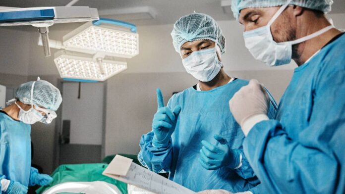 The Bundibugyo strain of Ebola, a catch-all term used for a group of viruses that damage the organs and lead to internal bleeding, continues to <a href="https://www.thestreet.com/travel/an-air-france-flight-to-the-u-s-was-diverted-over-ebola-fear">spread through several African</a> countries.The latest statistics from the World Health Organization (WHO) indicate at least 1,926 infections and 702 deaths in the Democratic Republic of Congo, South Sudan, and Uganda, <a href="https://www.reuters.com/business/healthcare-pharmaceuticals/ebola-outbreak-is-least-double-formal-tally-who-says-2026-07-14/">Reuters</a> reported.On July 14, the second American who was in the Democratic Republic of Congo through his work for a humanitarian aid organization was confirmed to be infected with the virus and transferred to Germany for medical care, <a href="https://abcnews.com/Health/2nd-american-infected-ebola-drc-evacuated-germany-chief/story?id=134709091">ABC News</a> confirmed.U.S. bans citizens in Congo from coming home for 21 days over Ebola riskWhile the risk of contracting the virus outside the affected regions remains low, multiple countries have taken measures to restrict travel from countries in the midst of an outbreak. In May 2026, the U.S. Centers for Disease Control and Prevention (CDC) <a href="https://www.thestreet.com/travel/u-s-bans-entry-for-non-citizens-who-visited-these-three-countries">implemented a new entry ban</a> on any non-citizens who traveled to Uganda, the DRC, or South Sudan in the last 21 days, and Canada and Mexico enacted similar travel restrictions.<strong><a href="https://www.thestreet.com/travel/canada-bahamas-ban-certain-travelers-over-ebola">Related: Two new countries ban certain travelers over health crisis</a></strong>Early reporting <a href="https://www.reuters.com/business/healthcare-pharmaceuticals/us-block-citizens-congo-immediate-travel-home-citing-ebola-2026-07-14/">from Reuters</a> cites an unnamed White House official who confirmed that the Trump administration will place citizens who are currently in or have recently left the Congo on a "do not board list" until they have spent 21 days waiting out potential exposure in a third country.The decision goes off Title 49 in the U.S. Code of Federal Regulations that relates to transportation security and can implement certain bans in cases where travel can create a health safety risk.Prior to the latest change, U.S. citizens and those with permanent residency who have been to the Congo since the start of the outbreak were permitted to return home but needed to do it through one of four major airports equipped to screen them as a public health risk, according to the <a href="https://www.cdc.gov/ebola/situation-summary/returning-travelers.html">CDC</a>.
The latest Ebola outbreak began from the Bundibugyo strain.<a href="https://www.shutterstock.com/image-photo/surgery-documents-surgeons-teamwork-emergency-accident-2442075837?trackingId=1ee7826d-4785-4ce1-814c-ae4c0c38cf69&listId=searchResults">PeopleImages/Shutterstock</a>
What happens to Americans who have been to countries with an Ebola outbreak?The White House official said the unprecedented measure of temporarily preventing Americans from returning home was made under the direct order of Department of Health and Human Services Secretary <a href="https://www.thestreet.com/personalities/robert-f-kennedy-jr-net-worth">Robert F. Kennedy Jr.</a>The official said approximately two dozen Americans who had planned to board flights returning home from Africa on July 14 have been or will be <a href="https://www.thestreet.com/travel/canada-bahamas-ban-certain-travelers-over-ebola">denied boarding as they are asked to wait</a> out the 21-day period in third countries that have not been named.<strong>More Travel News</strong>:<a href="https://www.thestreet.com/travel/airline-to-launch-unusual-new-flight-to-cayman-islands-from-the-u-s"><strong>Airline to launch unusual new flight to Cayman Islands from the U.S.</strong></a><strong><a href="https://www.thestreet.com/travel/there-is-a-very-cool-irish-version-of-swimming-pigs-in-the-bahamas">There is a very cool Irish version of swimming pigs in the Bahamas</a></strong><a href="https://www.thestreet.com/travel/unexpected-country-is-most-luxurious-travel-destination-for-2026"><strong>Unexpected country is most luxurious travel destination for 2026</strong></a><a href="https://www.thestreet.com/travel/low-cost-airline-launches-easier-way-to-get-to-sri-lanka"><strong>Low-cost airline launches easier way to get to Sri Lanka</strong></a>"CDC temporarily restricted U.S. entry for certain travelers who were recently in DRC, Uganda, or South Sudan," the government agency writes on a website addressing the Ebola outbreak that, as of Tuesday, July 14, has not been updated with the latest guidance.The official stated that the State Department would support any stranded Americans during the waiting period, but it is not immediately clear how they would do this in a third country. The second American confirmed to have Ebola in the DRC was transferred to Frankfurt University Hospital for treatment on July 13.<strong><a href="https://www.thestreet.com/travel/tsa-issues-stern-warning-about-summer-cooking-item">Related: TSA issues strong warning about summer cooking item</a></strong>