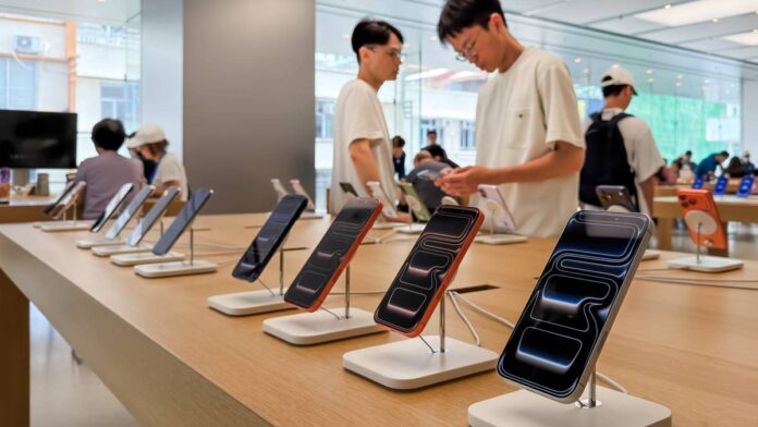 On June 25, Apple told the market it was raising prices on MacBooks, iPads, and other devices to cover the cost of a global memory chip shortage. The stock fell sharply that day, wiping out everything it had gained year to date. For a company that had been on a strong run, it was a rough afternoon.Three weeks later, Apple shares were trading at new all-time highs. And on July 13, Citi analyst Asiya Merchant raised her price target on the stock to $365 from $315, maintaining a buy rating and telling clients the company still has roughly 16% more upside from here, according to <a href="https://www.barchart.com/story/news/3258243/citi-just-upped-its-price-target-on-apple-stock-here-s-why">Barchart</a>.<strong>What Citi's analyst said on Apple stock and what she's actually betting on</strong>Merchant's thesis isn't complicated. The smartphone and PC markets are in rough shape, likely down a mid- to high-teens percent in 2026. Apple is gaining ground anyway. That gap between where the market is going and where Apple is going is what she's paying for.According to her note, Apple is expected to reach a record smartphone <a href="https://www.thestreet.com/dictionary/m/market-share">market share</a> of around 25% this year, up about two percentage points from where it was, <a href="https://www.investing.com/news/stock-market-news/apple-stock-target-raised-as-citi-sees-continued-market-share-gains-4788552">Investing.com reported</a>. <strong>More Apple:</strong><a href="https://www.thestreet.com/technology/apple-price-hike-ai-memory-shortage-buy-now"><strong>Apple just billed you for the AI buildout you never asked for</strong></a><a href="https://www.thestreet.com/investing/apples-gamble-just-exposed-the-ai-bubbles-fatal-flaw"><strong>Apple’s gamble just exposed the AI bubble’s fatal flaw</strong></a><a href="https://www.thestreet.com/investing/bank-of-america-buy-rating-apple-stock-after-siri-ai-shift"><strong>Bank of America resets Apple stock forecast after Siri AI shift</strong></a>The company is doing this through design-driven demand, strong mid-range positioning through promotions and subsidies, and an ecosystem that keeps people from switching. <a href="https://www.thestreet.com/investing/stocks/morgan-stanley-resets-apple-stock-price-target-after-earnings">As TheStreet reported</a>, Apple guided gross margins to 47.5% to 48.5% for the June quarter despite rising memory costs, signaling that its pricing power is holding. Merchant sees the June price increases on Macs and iPads not as a red flag, but as further evidence of that strength.Merchant isn't counting on Apple Intelligence to push people to upgrade. That story hasn't really materialized yet, and she doesn't expect it to drive a meaningful hardware cycle. Yet she thinks a smarter Siri keeps people inside the Apple ecosystem longer, and people who stay in the ecosystem tend to spend more on subscriptions. That's the services angle, and it's where Apple actually generates much of its profitability.<strong>How Apple is winning while the device market shrinks</strong>Apple's PC business put up 10.1% growth in the second quarter of 2026 in a market that was going the other way. That kind of performance in a down market comes from a few structural advantages the company has built up over years.Apple's <a href="https://www.thestreet.com/dictionary/s/supply-chain">supply chain</a> is a big part of what makes this work. Most of its competitors buy memory on the spot market, so when prices spike, their costs spike with them and margins take the hit. Apple operates differently. It has long-term supplier agreements, tightly controlled hardware specs, and a customer base that's used to paying more and tends to stay anyway. That's why it could raise prices on MacBooks and iPads in June and still be trading at all-time highs three weeks later.The June 25 sell-off looked bad in real time. But in hindsight, the market was punishing Apple for doing something that actually demonstrated pricing power. The stock has since recovered about 15% from that low, and Merchant's note is essentially saying that recovery still has room to run.
The iPhone 18 launch is when Merchant expects investor sentiment to really shift.Cheng/Getty Images
<strong>The two events on Apple's calendar that matter most right now</strong>Apple reports Q3 earnings on July 30, and the setup heading in looks strong. Consensus has the company earning $1.88 per share, which would be a 19.75% increase year over year, <a href="https://seekingalpha.com/news/4613175-apple-in-focus-as-citi-ups-price-target-ahead-of-earnings">Seeking Alpha noted</a>. For a company Apple's size, that kind of EPS growth is genuinely impressive, and it's part of why the stock has been resilient, even when the broader market got nervous.After earnings, the next big catalyst is September. The iPhone 18 launch is when Merchant expects investor sentiment to really shift. She frames it as a significant inflection point, the moment when hardware momentum becomes visible in actual demand data rather than just analyst projections.There's one complication worth noting. Apple filed suit against OpenAI earlier this month, accusing the company of systematically stealing its trade secrets to fuel its own hardware ambitions. The case adds legal complexity to Apple's <a href="https://www.thestreet.com/tag/artificial-intelligence">AI</a> story at a moment when the company is trying to position Siri and its services business as a long-term growth driver. Merchant's note doesn't address the lawsuit, but investors heading into July 30 will likely want to hear how management talks about it.<strong>Where Citi's higher Apple price target fits in the broader Wall Street picture</strong>Citi isn't alone in turning more bullish on Apple. JPMorgan had already raised its target to $345 earlier this year. Merchant's $365 now sits above that, making Citi one of the more constructive voices on the stock among major banks heading into the second half of 2026.At current prices around $316, a $365 target implies a lot still needs to go right. Apple's P/E sits at about 38 times earnings, which is a premium valuation for any company, let alone one in a mature hardware category. Merchant's answer is that the premium is justified by share gains and pricing power that most hardware companies can't replicate.Apple is up nearly 30% from its March low. The stock was at all-time highs on July 13. And Citi thinks that even with all of that already in the price, there's more to come. Whether that holds through earnings, through the iPhone launch, and through the OpenAI lawsuit will be the real test of how much of Merchant's thesis the market is willing to price in.<strong><a href="https://www.thestreet.com/technology/apple-sues-openai-ai-ip-theft-concerns-supports-alex-karp-warnings">Related: Apple stock move vindicates Palantir CEO warning for AI industry</a></strong>
