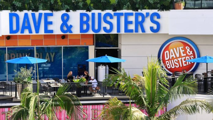 Dave & Buster’s has spent much of the past year trying to revive traffic.
It is working to enhance the value of its games and strengthen its food business as consumers become more selective in their discretionary spending.
The restaurant and entertainment chain, which combines arcade games, food, and sports viewing under one roof, has also been reshaping its leadership team.
All this as it pulls back on new-store spending while working through a broader turnaround.
That effort faced another setback after Dave & Buster’s reported weaker <a href="https://ir.daveandbusters.com/news-releases/news-release-details/dave-busters-reports-second-quarter-2026-financial-results">second-quarter 2027 results</a> on Sept. 15.
The company posted revenue of $544.1 million, down from $557.4 million a year earlier, while comparable-store sales declined 2.9%.
Dave & Buster’s also reported $12.5 million in net loss, or 36 cents per diluted share, compared with net income of $11.4 million, or 32 cents per share, a year earlier.
Adjusted EBITDA fell to $98.9 million from $129.7 million.
The results added to pressure on a stock that has already fallen sharply this year.
The company’s shares dropped following the report, touching a new 52-week low of $6.45 on Sept. 16 before slightly recovering later in the day.
Dave & Buster’s stock is down over 56% year-to-date and nearly 65% over the past 12 months.
The stock has also lost more than 30% over the past month and nearly 39% over the past three months.
These declines reflect a central problem facing the company, its higher-margin entertainment business, which has historically defined Dave & Buster’s, remains under pressure.
Even as its food and beverage sales are improving,
Dave & Buster’s arcade business under pressure
The company’s sales mix has become one of the biggest challenges facing its turnaround.
Food and beverage comparable sales increased 7.6% during the second quarter and have now been positive for five consecutive quarters.
But the entertainment side of the business continues to struggle, even as Dave & Buster’s rolls out new games and changes how much customers pay to play.
<strong>More Restaurants:</strong>
<a href="https://www.thestreet.com/restaurants/54-year-old-international-restaurant-chain-closing-all-locations"><strong>52-year-old international restaurant chain closing all locations</strong></a>
<a href="https://www.thestreet.com/restaurants/applebees-restaurant-chain-plans-35-closures-in-2026"><strong>46-year-old casual dining chain closes underperforming locations</strong></a>
<a href="https://www.thestreet.com/restaurants/74-year-old-skyway-drive-in-restaurant-chain-closes-its-final-location"><strong>Classic burger chain has closed down all its restaurants</strong></a>
During the earnings call, analysts noted that entertainment sales had declined year over year for roughly 8 quarters.
It raises the question of whether the game-focused model itself had become less attractive to consumers.
<a href="https://finance.yahoo.com/quote/PLAY/earnings/PLAY-Q2-2027-earnings_call-692366.html?guccounter=1&guce_referrer=aHR0cHM6Ly93d3cuZ29vZ2xlLmNvbS8&guce_referrer_sig=AQAAAHl8ruyIlXdyORss_kxIqTSY1qIhuABXGKwPxPBo9YggorYKvBnJ4Z_ANAjPAoKu425ztl-AxidH6AoDRLm6MZzqFLOq41lEhu3pq3tNGfLPnmJQa9wUmxYfVFfRnFO2d_naiie_49Dyr2XNWvOgiGQkD0j4OCnvNq4oyuHP_-3e">CEO Darin Harper said</a> the company’s consumer research continues to show demand for out-of-home gaming, but acknowledged that Dave & Buster’s has not kept its arcade floors innovative and relevant enough.
“You see other concepts out there with similar type offerings that are able to grow. Where we have not delivered great is that ongoing innovation and ongoing relevancy in our game room floor,” said Harper.
Further noting, “We have to innovate more, and we have to be more relevant for the guest.”
Management said the company has underinvested in its midway over the past several years and needs to catch up through new games, intellectual-property partnerships, and other entertainment experiences.
Dave & Buster’s has launched 10 new games and attractions this year, including experiences tied to The Mandalorian and Grogu, John Wick, Stranger Things, and Hot Wheels.
Management said more than 70% of guests surveyed indicated that learning about new games or activities would encourage them to visit more often.
The company has also changed game pricing in an effort to give customers more value.
Harper said the changes allow customers to play longer while spending roughly the same amount on entertainment, resulting in gameplay and dwell-time increases of about 16% to more than 20%.
The hope is that customers who stay longer will also spend more on food and drinks.
Dave & Buster’s said its Eat & Play Combo has already helped convert some customers who previously came only to play games into food-and-beverage customers.
Dave & Buster’s stock is down 56% year to date.<a href="https://www.gettyimages.com/detail/2254343261">Walter Cicchetti / Getty Images</a>
Dave & Buster’s sees early signs of improvement
There are some indications that the company’s sales trends may be stabilizing.
Comparable-store sales fell 5% in June before improving to a 1.6% decline in July.
Management said trends improved further during the first five weeks of the third quarter and expects better top-line performance over the remainder of the year.
Dave & Buster’s has also found some success tying its stores to major sporting and cultural events.
Management said World Cup activations generated double-digit sales growth during some matches as the company used themed food, games, and watch experiences to draw customers into its locations.
The company plans to lean further into those occasions as it tries to position Dave & Buster’s as a destination for sports viewing, celebrations, and other group outings.
Still, the broader consumer environment remains difficult.
Harper said lower-income consumers have been affected more heavily by current economic pressures.
But he also acknowledged that Dave & Buster’s cannot blame all of its challenges on the economy because other brands operating in the same environment have performed better.
The company is emphasizing value through offers, including its Eat & Play Combo and half-price games on Wednesdays and Sundays.
Wall Street cuts Dave & Buster’s price targets
Wall Street analysts have also become more cautious following the quarter.
UBS analyst Dennis Geiger lowered the firm’s price target to $9 from $12 and maintained a Neutral rating.
Geiger said sales trends are showing early improvement, but greater-than-expected margin and earnings pressure, elevated macroeconomic risks, and limited visibility leave the turnaround in its early stages.
BMO Capital analyst Andrew Strelzik lowered the firm’s price target to $13 from $22 while maintaining an Outperform rating.
Strelzik described the quarter as showing “better comps but a worse sales mix.”
BMO also pointed to limited visibility into an improvement in amusement sales, intensifying consumer pressure, and another leadership transition.
Dave & Buster’s reshapes leadership
The turnaround is happening alongside a broader reshuffling of Dave & Buster’s management team.
Amanda Busby joined the company in August as chief operating officer.
Rachel Morgan was promoted to chief legal and administrative officer and corporate secretary, expanding her responsibilities to include oversight of the legal and human resources organizations.
Aldo Rosales was promoted to chief strategy and revenue management officer.
Those changes followed other recent executive additions, including Jeremy Tucker as chief marketing officer, Kevin Fish as chief technology and digital officer, and Derek Sample as chief accounting officer.
Management said the leadership overhaul is intended to improve operations, accelerate digital initiatives, and restore sales growth.
Dave & Buster’s is also becoming more selective about expansion.
The company opened seven domestic stores during the first half of fiscal 2026 but plans to open only four more during the remainder of the year and five during fiscal 2027.
Dave & Buster’s currently operates 250 company-owned stores, including 184 Dave & Buster’s locations and 66 Main Event locations, along with six international franchise stores.
The company has also identified $15 million in cost savings expected to be realized over the next 12 months.
It is targeting at least double this amount as it searches for additional expenses that can be removed without affecting customers.
Dave & Buster’s is now trying to convert its stronger food sales, better value, and a revamped leadership team to revive its amusement business that has historically been at the center of the chain.
<strong><a href="https://www.thestreet.com/retail/49-year-old-christmas-retailer-gordon-companies-files-chapter-11-bankruptcy">Related: 49-year-old Christmas retailer files Chapter 11 bankruptcy</a></strong>