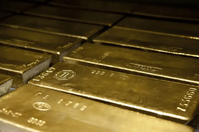Gold did not fall on Friday because inflation is beaten. It fell because the man who decides the price of money said the opposite. Spot gold closed 28 August 2026 at roughly $4,456 an ounce, down 3.2% on the day, after Federal Reserve Chairman Kevin Warsh used his first Jackson Hole keynote to tell the market that underlying inflation has not improved and that the Fed may still have work to do. That is the second time in seven months that a single Warsh event has repriced gold. The first was 30 January 2026, the day President Trump nominated him: gold fell 10.3% and silver 28.5% in one session, and the January high of about $5,405 has not been revisited since. Any honest gold price prediction has to start by admitting that this market's two worst days in a year were both about one person.
Now the part that complicates the bearish reading. While gold fell through the second quarter, central banks bought 289 tonnes of it, a 62% jump on the same quarter a year earlier and the strongest second quarter in the World Gold Council's data series. Over the same three months, gold ETFs shed 45 tonnes as Western investors marked up their rate expectations. Two groups looked at an identical falling price and did opposite things, and the official sector bought roughly 6.4 times what the funds sold. That is the single most important fact in gold right now, because it means the marginal buyer of gold is not rate-sensitive. Warsh sets gold's price week to week. He does not set the bid underneath it. The distance between those two statements is the entire bull-bear spread.
Key facts: gold in seven numbers
<strong>Spot gold $4,456/oz</strong> at the 28 August 2026 close, down 3.2% on the day and 17.5% below the January peak of roughly $5,405, but still up 29.8% over twelve months. <em>Sources: Trading Economics, gold-api, SPDR Gold Shares closes.</em>
<strong>Central banks bought 289 tonnes in Q2 2026</strong>, up 62% year on year and the strongest Q2 on record, led by the National Bank of Poland at 51 tonnes. <em>Source: World Gold Council, Gold Demand Trends Q2 2026.</em>
<strong>Gold ETFs sold 45 tonnes in Q2 2026</strong>, with North America accounting for 61 tonnes of outflow across the first half while Asia added 70 tonnes. <em>Source: World Gold Council.</em>
<strong>PCE inflation is 3.7% over twelve months and 4.1% over six</strong>, meaning the Fed's preferred gauge is accelerating, not decaying. <em>Source: Chairman Kevin Warsh, Jackson Hole, 28 August 2026.</em>
<strong>Gold fell 10.3% and silver 28.5% on 30 January 2026</strong>, the day Warsh was nominated as Fed Chair. That day marked the top. <em>Sources: SPDR Gold Shares and iShares Silver Trust closes; CNN.</em>
<strong>The gold-silver ratio is 67:1</strong>, against 46:1 at the January peaks and 88:1 twelve months ago. Silver is 43.2% below its January high; gold is 17.5% below its own. <em>Source: FinanceFeeds calculation from ETF closes.</em>
<strong>Every major bank 2027 target sits above spot</strong>, from UBS at $5,200 by June 2027 to J.P. Morgan at $6,300 by end-2027. There is no published bear case. <em>Sources: bank research summaries, August 2026.</em>
What Warsh actually said, and why it moved gold
It helps to read the speech rather than the headline. Warsh titled his remarks "In Our Time" and delivered them on his 100th day as Chairman. The passage that moved the market was not a rate signal at all; it was a standard. "Here is my standard," he said. "We must be confident that underlying inflation is moving to our objective, clearly and at sufficient speed. Otherwise, we have work to do."
The arithmetic behind that sentence is what should worry a gold bear and a gold bull simultaneously. Warsh noted that the twelve-month change in the PCE price index stands at 3.7%, "while the six-month change is 4.1 percent." A six-month rate running above the twelve-month rate means inflation is accelerating. He was explicit that the summer's better-than-expected prints "do not tell me that underlying trends have meaningfully improved," and blunter still on accountability: "The responsibility for 65 months of sustained, elevated inflation sits squarely with the central bank. And that is where it belongs."
Markets read that as a September hike becoming live, the dollar firmed, yields rose, and gold, which pays no coupon, did what a zero-yield asset does when the discount rate jumps. That is the textbook mechanism and it worked exactly as advertised for one session.
The textbook stops working when you zoom out. Over the twelve months in which the Fed went from cutting to openly discussing hikes, and in which a self-described inflation hawk took the chair, gold rose 29.8%. If rising real rates reliably sank gold, that number would be negative. It is not. Something is bidding for gold that does not read the dot plot, and the World Gold Council data says plainly what it is.
Who was buying while the price was falling
The second quarter is the cleanest natural experiment gold has offered in years, because the price fell and the two big buyer groups moved in opposite directions.
Central banks bought 289 tonnes, a 62% increase on Q2 2025 and the strongest second quarter in the World Gold Council's series. The National Bank of Poland was the largest single buyer at 51 tonnes, taking its reserves to 632 tonnes by the end of June. The People's Bank of China added 33 tonnes, its biggest quarterly addition since the fourth quarter of 2023. None of these institutions bought because they expected a rate cut. They bought because they are diversifying reserves away from assets that another government can freeze, and a falling price makes that cheaper.
Exchange-traded funds did the opposite, shedding 45 tonnes over the quarter in response to weaker prices and upward revisions to both inflation and interest rate expectations. The regional split is the tell: across the first half, North American funds lost 61 tonnes while Asian funds added 70 tonnes and European funds added 8 tonnes. The marginal seller of gold is Western and rate-driven. The marginal buyer is Eastern, official, and policy-driven.
This is a pattern anyone who has covered commodity markets will recognise from oil's strategic petroleum reserve dynamics, where a price-insensitive sovereign buyer sets a soft floor that private speculators repeatedly underestimate. It is also why our recent <a href="https://financefeeds.com/gold-price-forecast-2026-central-bank-demand/">analysis of central bank gold demand</a> concluded that forecasters cannot agree on where gold ends up: they are modelling a private-sector asset that has acquired a public-sector buyer of last resort.
The silver test, and what it proves about gold
If you want to know whether gold's decline is a monetary story or a positioning story, compare it with silver. The two metals peaked within a day of each other in late January. Since then silver has fallen 43.2% while gold has fallen 17.5%. The gold-silver ratio, which compressed to about 46:1 at the twin peaks, now sits at 67:1, having been 88:1 a year ago.
That divergence is diagnostic. Silver's January move was a speculative and industrial mania, and manias unwind violently: silver lost 28.5% in the single session of 30 January and another 15.8% a week later. Gold's worst day in the same episode was 10.3%, painful but a third of silver's. Both metals lost their speculative bid at the same moment. Only gold retained a second, separate bid underneath it, and that second bid is the official sector. Readers weighing the two should also see our <a href="https://financefeeds.com/silver-price-prediction-100-bull-case-45-bear-case/">silver price prediction</a>, which treats the industrial demand side that gold simply does not have.
The practical conclusion for a long-term holder is that gold and silver are not the same trade and should not carry the same position sizing. Silver offers more upside per unit of the same macro thesis and considerably more drawdown. At 67:1 the ratio sits close to the middle of its twelve-month range, which means neither metal currently screens as obviously cheap against the other. That is an unglamorous finding, and it is more useful than a target.
Gold spot to 28 August 2026 against the $6,200 bull and $3,800 bear cases, with the two Warsh events marked, and Q2 2026 central bank buying against gold ETF flows. Sources: World Gold Council Gold Demand Trends Q2 2026; prices derived from SPDR Gold Shares closes calibrated to spot.
The long-term case: what has to be true by 2028
<strong>The bull case, and how we get to $6,200.</strong> It requires the official bid to persist and the Western bid to return. The first is already happening and the World Gold Council expects another strong year, if below 2025. The second is a rates question: North American ETFs shed 61 tonnes in the first half precisely because rate expectations rose, which means that flow reverses mechanically once the market stops pricing hikes. Add a returning Western bid on top of an official bid that never left, and gold clears the January high of $5,405. Extending roughly 15% beyond that prior peak, which is a modest overshoot by the standard of previous gold cycles, gives approximately $6,200. That sits above UBS's $5,200 June 2027 path and just below J.P. Morgan's $6,300 end-2027 figure, so it is a bull case, not a fantasy.
<strong>The bear case, and how we get to $3,800.</strong> Warsh hikes in September and again before year-end, real yields rise by something like a percentage point, and gold's historical sensitivity to real rates of roughly 8% to 10% per 100 basis points drags it toward $4,010. Then add a genuine liquidation quarter: Q2's 45 tonnes of ETF outflow was orderly, and a disorderly one in a hiking scare could be three times that. The overshoot takes gold to about $3,800. Note what this bear case still concedes. Even at $3,800 gold sits 11% above its twelve-month low of roughly $3,433, because the official bid raises the floor even when it cannot hold the ceiling.
<strong>The structural change nobody is pricing.</strong> Buried in the same speech, Warsh announced that he intends to dismantle forward guidance, saying the practice "has overstayed its welcome" and that he prefers his commitment to be "to a discipline, not to a decision." For equities that is a communication story. For gold it is a valuation input. Forward guidance existed to suppress volatility in the expected path of rates; removing it raises the variance of that path even if the average level is higher. Gold is, among other things, a long-dated option on monetary disorder, and options are worth more when variance rises. A hawkish chair who also removes the market's forward visibility is not straightforwardly bearish for gold, and this is the piece of Friday's speech that the one-day 3.2% selloff did not price at all.
The political risk that cuts both ways
There is a second-order risk here that is unusual to see priced explicitly. The Wall Street Journal has reported that President Trump has called Warsh repeatedly since he became Fed Chair, and Warsh's own framing at Jackson Hole, placing responsibility for 65 months of inflation squarely on the central bank, reads as a man defending institutional prerogative rather than accommodating the White House. Prediction markets currently put roughly a 10% probability on Warsh being out as Fed Chair.
That 10% is a genuinely two-sided number for gold, and it is worth being precise about why. If Warsh stays and hikes, the near-term path is the bear case. If Warsh is removed for refusing to cut, the message to every reserve manager on earth is that US monetary policy is subject to political override, which is the single most powerful argument for holding a reserve asset that no government issues. In that scenario the official-sector buying that already runs at 289 tonnes a quarter accelerates rather than fades. Gold is therefore short the Fed's hawkishness and long the Fed's fragility at the same time, which is precisely why it can fall 3.2% on a hawkish speech and still be up 29.8% on the year. The same tension is visible in rate positioning, as our coverage of <a href="https://financefeeds.com/traders-have-2-6-million-on-the-september-fed-meeting-and-they-are-buying-both-a-cut-and-a-hike/">traders buying both a cut and a hike into September</a> showed.
What happens next: three predictions
<strong>One: the September meeting matters less than the November PCE prints.</strong> Warsh committed to "a discipline, not to a decision," and with the six-month PCE rate at 4.1% against 3.7% over twelve months, the data decides. We expect no hike in September and a live one by year-end if the six-month rate stays above the twelve-month rate. Gold's floor holds through the meeting itself; the risk is in the data that follows.
<strong>Two: central bank buying prints above 250 tonnes again in Q3.</strong> The Q2 figure of 289 tonnes came with the price falling, Poland adding 51 tonnes and China adding 33. Nothing in the third quarter changed the reserve-diversification logic, and a lower price improves the entry. If Q3 comes in below 200 tonnes, the bull case weakens materially and the $3,800 bear case becomes the working assumption rather than the tail.
<strong>Three: the ETF flow, not the price, is the signal to watch.</strong> North American funds have been the marginal seller all year. The first quarter in which North American gold ETF flows turn positive while central bank buying holds is the moment both bids are pulling in the same direction, and that is historically when gold makes new highs rather than merely defending old ones.
The honest summary is that gold got cheaper on Friday without getting weaker. The price fell because one man raised the discount rate applied to a non-yielding asset. The demand that has actually driven this bull market, 289 tonnes a quarter from institutions that do not trade on Fed speeches, was unaffected by anything said in Wyoming. For a long-term holder, the useful question is not where gold trades in September. It is whether the official sector is still buying in 2028, and on the evidence of the last four years, the burden of proof sits with whoever argues that it stops. For the commodity complex more broadly, see our <a href="https://financefeeds.com/oil-price-prediction-120-bull-case-60-bear-case/">oil price prediction</a> and our work on <a href="https://financefeeds.com/mp-materials-stock-prediction-82-bull-case-38-bear-case/">strategic materials</a>.
Frequently asked questions
Why did gold fall on 28 August 2026?
Fed Chairman Kevin Warsh used his first Jackson Hole keynote to say that underlying inflation had not meaningfully improved and that the Fed may have "work to do," which markets read as making a September rate hike live. The dollar firmed and Treasury yields rose, and gold, which pays no yield, fell about 3.2% to roughly $4,456 an ounce.
What is a realistic gold price prediction for 2027?
The published bank range runs from UBS at $5,200 by June 2027 to J.P. Morgan at $6,300 by end-2027, with Goldman Sachs at $5,400 to $5,600 and Bank of America at $6,000 on a twelve-month view. Every one of those sits above the current $4,456 spot price. Our own bull case is $6,200 and our bear case is $3,800, and the bear case exists because no major bank currently publishes one.
Are central banks still buying gold in 2026?
Yes, and at an accelerating rate. The World Gold Council recorded 289 tonnes of central bank purchases in Q2 2026, up 62% year on year and the strongest second quarter in its data series, with Poland adding 51 tonnes and China 33 tonnes. Crucially, that buying occurred while the gold price was falling, which is what distinguishes official demand from investor demand.
Why is gold down 17.5% but silver down 43.2%?
Both metals peaked in late January 2026 and lost their speculative bid at the same time. Silver's demand is roughly half industrial and its January move was a mania, so it unwound violently, losing 28.5% in a single session on 30 January. Gold retained a second, non-speculative bid from central banks, which silver does not have. The gold-silver ratio has widened from 46:1 to 67:1 as a result.
Does a hawkish Fed automatically mean lower gold?
Not reliably. Over the past twelve months the Fed moved from cutting to openly discussing hikes and a noted inflation hawk took the chair, yet gold rose 29.8%. Rate expectations dominate day-to-day moves, but reserve diversification dominates the multi-year trend. Warsh's plan to retire forward guidance also raises the variance of the expected rate path, which increases rather than decreases the hedging value of holding gold.
What would invalidate the bullish case for gold?
A quarter in which central bank purchases fall below roughly 200 tonnes while ETF outflows continue would remove both legs of support and make the $3,800 bear case the base case. Sustained six-month PCE readings below the twelve-month rate would do similar damage, because that would signal the Fed is winning and the monetary hedge is less necessary.
<em>This article is for information only and is not investment advice. The $6,200 bull case and $3,800 bear case are FinanceFeeds estimates derived from published demand data and stated central bank policy, not price targets. Prices are as of the 28 August 2026 close. Primary sources: <a href="https://www.federalreserve.gov/newsevents/speech/warsh20260828a.htm">"In Our Time", keynote remarks by Chairman Kevin Warsh at the 2026 Jackson Hole Economic Policy Symposium</a>; <a href="https://www.gold.org/goldhub/research/gold-demand-trends/gold-demand-trends-q2-2026">World Gold Council, Gold Demand Trends Q2 2026</a>; <a href="https://www.cnn.com/2026/01/30/economy/kevin-warsh-nominated-fed-chair">CNN on the 30 January 2026 nomination</a>; <a href="https://tradingeconomics.com/commodity/gold">Trading Economics gold price data</a>.</em>