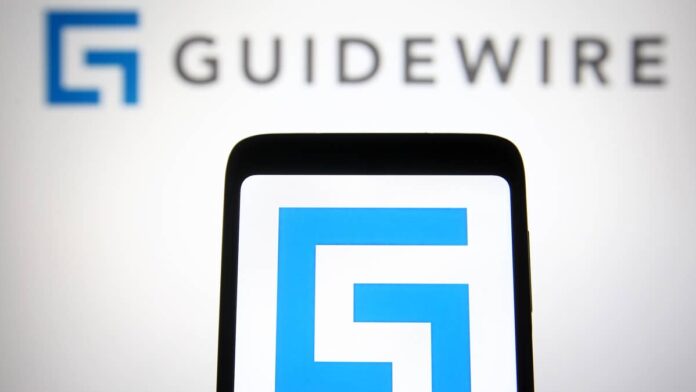 <strong>Guidewire Software</strong> (GWRE) just reported a strong final quarter.
The company beat both earnings and revenue expectations, and is still hiring steadily.
Yet on <strong>Friday</strong>, <strong>Sept. 4, 2026</strong>, its stock <strong>dropped about 20%</strong> in a single session, closing <strong>near $162.42</strong>.
That contrast is worth noticing. The company is hiring like business is strong, but investors sold off like something is wrong.
This gap could be a sign that Wall Street is not on the same page as the company about how soon it can deliver the growth that investors want.
What Guidewire does and how it earns its money
Guidewire builds the software that property and casualty (P&C) insurers use to run daily operations, including writing policies, sending documents, and settling claims.
Insurers pay recurring fees to use cloud platforms like <strong>InsuranceSuite</strong>.
InsuranceSuite runs on annual recurring revenue (ARR), which is the yearly value of those long-term contracts.
Guidewire holds a commanding position here.
<strong>Nine of the top 10</strong> global insurers use its platform, and it now has <strong>$858 billion</strong> in active insurance policies, <a href="https://ng.investing.com/news/stock-market-news/guidewire-q4-fy26-slides-strong-results-growth-outlook-disappoints-93CH-2685214">Investing.com</a> reported.
Guidewire’s cloud software runs core operations for property and casualty insurers, from underwriting to claims.<a href="https://www.gettyimages.com/detail/1232815721">SOPA Images / Getty Images</a>
Why GWRE stock fell despite a strong quarter
The results themselves were solid.
<a href="https://ir.guidewire.com/news-releases/news-release-details/guidewire-announces-fourth-quarter-and-fiscal-year-2026">Guidewire</a> confirmed its fourth-quarter revenue <strong>rose 15% to $411 million</strong>, and adjusted earnings of <strong>$0.99 per share</strong> beat expectations.
The problem was in the forecast.
Guidewire guided fiscal 2027 ending ARR to a range of <strong>$1.45 billion to $1.46 billion</strong>, which points to <strong>about 18% growth</strong>, <strong>down from 19%</strong> in fiscal 2026.
First-quarter revenue guidance of <strong>$372 million to $378 million</strong> also came in below the <strong>roughly $395 million</strong> Wall Street had modeled, <a href="https://www.chartmill.com/news/GWRE/Chartmill-54359-Guidewire-Software-NYSEGWRE-Tumbles-on-Soft-Fiscal-2027-Outlook-Despite-Q4-Beat">ChartMill</a> reported.
<strong>More Software Stocks:</strong>
<a href="https://www.thestreet.com/investing/stocks/now-servicenow-stock-bank-of-america-raises-now-stock-price-target-august-2026"><strong>ServiceNow investors must consider latest alert from Bank of America</strong></a>
<a href="https://www.thestreet.com/investing/stocks/cramer-palantir-salesforce-rebound"><strong>Cramer reveals what revived Palantir, Salesforce stocks</strong></a>
<a href="https://www.thestreet.com/investing/stocks/michael-burry-warns-palantir-stock-investors-bear-case"><strong>Michael Burry sends a strong warning to Palantir stock investors</strong></a>
Here’s the catch.
GWRE trades at a rich valuation, with a <strong>price-to-earnings ratio near 99</strong>. When a stock is priced that highly, even a small slowdown in the growth outlook forces the market to lower its valuation.
The stock had also <strong>climbed about 20%</strong> in the month before the report, which raised the bar for what the guidance needed to deliver.
Why the company keeps hiring while the stock sells off
Here is the part that pushes against the sell-off.
Guidewire has kept expanding its workforce, reaching <strong>roughly 4,066 employees</strong>, according to <a href="https://www.reveliolabs.com/companies/guidewire-software/employees">Revelio Labs</a>.
Building and deploying cloud systems for large insurers requires people, so steady hiring points to real demand for migrations and deployments.
<strong><a href="https://www.thestreet.com/investing/stocks/jim-cramer-names-six-stocks-nvidia-coreweave-nebius-ai-data-center-trade">Related: Jim Cramer reveals 6 AI stocks to watch in 2026</a></strong>
The recent quarter backs that up.
Insurer <strong>Nationwide</strong>, a Fortune 100 company, agreed to move all of its Guidewire software over to the cloud version.
<strong>MAPFRE US</strong> and <strong>AF Group</strong> also expanded their use of the platform.
Chief Financial Officer <a href="https://ir.guidewire.com/corporate-governance/management">Jeff Cooper</a> said <strong>more than half</strong> of the new ARR in the outlook is already under contract, with signed agreements and confirmed rollout dates.
What GWRE investors should watch next
For anyone considering the stock, a few signals are worth watching:
Whether <strong>ARR growth </strong>holds near 18% rather than slipping further
Whether the<strong> larger workforce</strong> turns onboarding backlogs into faster ARR
Whether Guidewire keeps <strong>customer losses low</strong> as attrition returns to normal after an unusually strong year
There are real risks here.
Large insurance migrations move slowly and involve many moving parts. Legacy license revenue keeps shrinking as customers move to the cloud.
On top of that, the stock’s premium valuation leaves little room for error if execution slips.
The business is working well and its management is still investing in growth, but the market wanted faster near-term numbers than the fiscal 2027 outlook offered.
Patient investors are betting the hiring push and signed backlog convert into stronger ARR.
Investors watching the next few quarters will want to see growth stabilize before the stock regains its premium valuation.
<strong><a href="https://www.thestreet.com/investing/stocks/morgan-stanley-ai-stock-outlook-spending-boom-intact">Related: Morgan Stanley has a strong message for worried AI stock investors </a></strong>