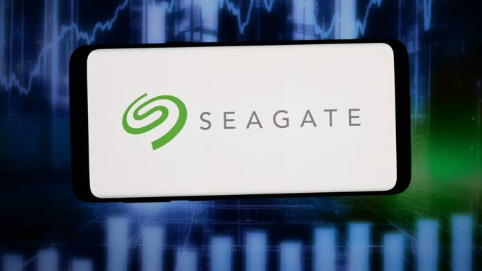 Seagate Technology (<a href="https://www.thestreet.com/quote/STX">STX</a>) and Western Digital (<a href="https://www.thestreet.com/quote/WDC">WDC</a>) supply high-capacity hard drives used by cloud providers to store the growing volumes of data produced by artificial intelligence workloads.The companies have become two of the market’s most closely watched <a href="https://www.thestreet.com/tag/artificial-intelligence">AI</a> infrastructure stocks as hyperscalers expand data-center capacity and reserve hard-drive supply years in advance.Both stocks moved sharply lower on July 27 despite a bullish analyst call.Seagate shares fell about 6.1% to $800 around midday July 27, and Western Digital declined about 6.1% to $487.87.Seagate will <a href="https://investors.seagate.com/news/news-details/2026/Seagate-Technology-to-Report-Fiscal-Fourth-Quarter-and-Fiscal-Year-2026-Financial-Results-on-July-28-2026/default.aspx">report fiscal fourth-quarter and full-year results after the market closes on July 28</a>. Western Digital is <a href="https://investor.wdc.com/news-releases/news-release-details/wd-announce-fourth-quarter-and-fiscal-year-2026-financial">scheduled to report on Aug. 5</a>.The reports will show whether limited hard-drive supply is still helping the companies raise prices and protect margins.They will also show whether production constraints are limiting the number of drives Seagate and Western Digital can deliver.Wedbush analyst<a href="https://www.tipranks.com/experts/analysts/matt-bryson"> Matt Bryson</a><a href="https://seekingalpha.com/news/4618647-seagate-western-digital-in-focus-as-wedbush-ups-price-targets-ahead-of-earnings">raised his Seagate price target to $1,000 from $825</a> and lifted his Western Digital target to $650 from $540.Bryson maintained Outperform ratings on both stocks.
<a href="https://www.gettyimages.com/detail/2285810497">SOPA Images / Getty Images</a>
<strong>Wedbush expects the HDD shortage to continue into 2027</strong>Wedbush expects growing demand and limited hard-drive supply to <a href="https://www.investors.com/news/technology/seagate-stock-earnings-july-2026-ai-stock/">continue well into 2027</a>.Cloud providers are reserving high-capacity drives as they expand storage for AI training data, inference output, customer records and backups.The shortage gives Seagate and Western Digital more leverage in negotiating new customer agreements because hyperscalers have fewer suppliers with available capacity.<strong><a href="https://www.thestreet.com/technology/nvidia-just-locked-down-a-deal-that-changes-the-ai-race-sk-hynix">Related: Nvidia just locked down deal that changes AI race</a></strong>However, higher market prices may take time to reach Seagate’s financial results.The company has already <a href="https://www.thestreet.com/investing/seagate-stx-stock-ceo-heat-assisted-magnetic-recording-ai-data-storage">committed much of its fiscal 2027 capacity through long-term agreements</a> that set volumes and pricing in advance.That means the strongest benefit may come when existing agreements reset or Seagate signs contracts for later delivery periods at higher prices.<a href="https://www.investors.com/news/technology/seagate-stock-earnings-july-2026-ai-stock/">Seagate had declined about 17% in July</a> entering Monday, while Western Digital had fallen more than 20%, according to Investor’s Business Daily.The <a href="https://www.thestreet.com/dictionary/p/pullback">pullback</a> shows investors are waiting for more details on contract pricing, available capacity, and whether limited production will prevent the companies from accepting additional orders.<strong>More AI:</strong><a href="https://www.thestreet.com/technology/open-source-china-zhipu-ai-anthropic-mythos-access-restored"><strong>The new Chinese AI model rattling U.S. tech investors</strong></a><a href="https://www.thestreet.com/technology/anthropic-restores-access-to-mythos-5-for-select-organizations-fable"><strong>Anthropic restores access to Mythos 5 for select organizations</strong></a><a href="https://www.thestreet.com/technology/softbank-son-musk-spacex-orbital-data-center-feud"><strong>SoftBank CEO offers stinging critique of Musk’s AI bet</strong></a><strong>AI expansion is increasing demand for mass-capacity storage</strong>AI models require storage before and after they run.Companies retain training datasets, model checkpoints, inference results, security logs, and customer information inside cloud data centers.High-capacity hard drives allow cloud providers to store large amounts of that information in a smaller physical footprint.A recent Bank of America report placed that demand inside a wider shift in technology investment.<blockquote>The debate around frontier technologies has shifted from experimentation to scalability.</blockquote>BofA did not mention Seagate or Western Digital in that section of the report.Its scalability framework helps explain why storage availability has become part of the AI infrastructure buildout alongside processors, networking equipment, and electricity.AI companies can experiment with limited computing capacity.Running those products for millions of customers requires much larger systems for computing, moving, and retaining data.The demand has already affected Seagate’s production planning.CEO Dave Mosley said in May that <a href="https://www.thestreet.com/investing/stocks/seagate-stock-price-falls-after-dave-mosley-rattling-warning">building new factories would take too long</a> and could leave the company with unused capacity if demand later weakened.Mosley said <a href="https://www.thestreet.com/investing/stocks/seagate-stock-price-falls-after-dave-mosley-rattling-warning">recording-head wafers had lead times exceeding nine months</a>.Finished drives required roughly another quarter after that stage.Seagate later said its <a href="https://www.thestreet.com/investing/seagate-stx-stock-ceo-heat-assisted-magnetic-recording-ai-data-storage">nearline capacity was almost fully allocated through calendar 2027</a>.Nearline drives are high-capacity products designed for cloud and enterprise data centers.<strong>The storage shortage can also cap revenue growth</strong>Limited supply can lift prices when customers compete for available capacity.It creates a different problem when manufacturers cannot produce enough drives to accept additional orders.Seagate and Western Digital therefore need to show that pricing gains outweigh the revenue they may be leaving behind due to constrained production.<strong><a href="https://www.thestreet.com/technology/zuckerberg-microsoft-ceo-ai-decision-open-source-jensen-huang-elon-musk">Related: Mark Zuckerberg, Microsoft CEO just made major AI decision</a></strong>Their margin benchmarks are already high.Seagate reported a <a href="https://investors.seagate.com/news/news-details/2026/Seagate-Technology-Reports-Fiscal-Third-Quarter-2026-Financial-Results/default.aspx">47% non-GAAP gross margin</a> in its fiscal third quarter, up from 36.2% a year earlier.The company forecast <a href="https://investors.seagate.com/news/news-details/2026/Seagate-Technology-Reports-Fiscal-Third-Quarter-2026-Financial-Results/default.aspx">fiscal fourth-quarter revenue of $3.45 billion</a>, plus or minus $100 million.It projected non-GAAP earnings of $5 a share, plus or minus 20 cents.Western Digital reported <a href="https://investor.wdc.com/news-releases/news-release-details/wd-reports-fiscal-third-quarter-2026-financial-results">fiscal third-quarter revenue of $3.34 billion</a> and a non-GAAP gross margin of 50.5%.It forecast fourth-quarter revenue of about $3.65 billion and a <a href="https://investor.wdc.com/static-files/5b2d41c1-7d45-4575-b9ea-c51424dbffeb">non-GAAP gross margin of approximately 51.5%</a>.Those results leave little room for a quarter that merely meets expectations.Investors will need evidence that new contracts are being signed at higher prices, recent margin gains can continue, and customer commitments extend beyond the capacity already reserved for 2027.<strong>Key numbers ahead of Seagate and Western Digital earnings</strong><a href="https://seekingalpha.com/news/4618647-seagate-western-digital-in-focus-as-wedbush-ups-price-targets-ahead-of-earnings"><strong>$1,000</strong></a><strong>:</strong> Wedbush’s new Seagate price target<a href="https://seekingalpha.com/news/4618647-seagate-western-digital-in-focus-as-wedbush-ups-price-targets-ahead-of-earnings"><strong>$650</strong></a><strong>:</strong> Wedbush’s new Western Digital price target<a href="https://investors.seagate.com/news/news-details/2026/Seagate-Technology-Reports-Fiscal-Third-Quarter-2026-Financial-Results/default.aspx"><strong>47%</strong></a><strong>:</strong> Seagate’s latest non-GAAP gross margin<a href="https://investor.wdc.com/news-releases/news-release-details/wd-reports-fiscal-third-quarter-2026-financial-results"><strong>50.5%</strong></a><strong>:</strong> Western Digital’s latest non-GAAP gross margin<a href="https://investors.seagate.com/news/news-details/2026/Seagate-Technology-Reports-Fiscal-Third-Quarter-2026-Financial-Results/default.aspx"><strong>$3.45 billion</strong></a><strong>:</strong> Seagate’s fiscal fourth-quarter revenue guidance midpoint<a href="https://investor.wdc.com/news-releases/news-release-details/wd-reports-fiscal-third-quarter-2026-financial-results"><strong>$3.65 billion</strong></a><strong>:</strong> Western Digital’s fiscal fourth-quarter revenue guidance midpoint<strong>Through 2027:</strong> Period for which Seagate’s nearline capacity was almost fully allocatedWedbush’s targets assume that constrained supply will continue supporting contract prices and margins.Seagate reports first, giving investors the earliest indication of whether the recent decline has reset expectations or reflects concern that profitability is approaching a peak.Western Digital will face the same test the following week.<strong><a href="https://www.thestreet.com/investing/stocks/cathie-wood-buys-50-1-million-of-tumbling-megacap-stock-tesla-tsla">Related: Cathie Wood buys $50.1 million of tumbling megacap stock</a></strong>