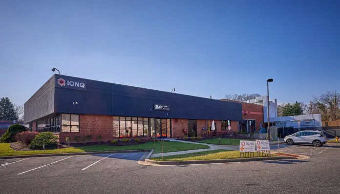 IonQ did not lose $1.9 billion last quarter. It earned record revenue, raised guidance, closed a $1.8 billion acquisition — and then booked a $1.6 billion non-cash charge <em>because its own share price went up</em>. That single accounting mechanic is the most misunderstood thing about IonQ (NYSE: IONQ) right now, and it explains why the headline "record quarterly loss" and the headline "record quarterly revenue" describe the same three months.
Here is the tell, and it is verifiable from IonQ's own filings. In Q1 2026, IONQ shares fell from $44.87 to $28.83 — a 35.7% decline — and IonQ reported <strong>net income of $805.4 million</strong>. In Q2 2026, the shares rose from $28.83 to $53.26 — up 84.7% — and IonQ reported a <strong>net loss of $1.87 billion</strong>. The company's warrant liability is, in effect, a short position on its own stock. When IONQ rallies, IonQ's income statement bleeds. Any price target built off GAAP earnings is measuring the share price, not the business.
With the stock at <strong>$46.84</strong> (17 August 2026 close), this piece sets out a <strong>$82 bull case</strong> and a <strong>$26 bear case</strong>, both anchored to the post-SkyWater balance sheet rather than to the sell-side's revenue-multiple guesswork.
Quick Take: the numbers that matter
<strong>Spot:</strong> $46.84 (17 Aug 2026 close). 52-week closing range $26.59 to $82.09 — <a href="https://stockanalysis.com/stocks/ionq/">StockAnalysis</a>
<strong>Q2 2026 revenue:</strong> $80.05m, +287% YoY, beating consensus of $66.4m — <a href="https://www.sec.gov/Archives/edgar/data/1824920/000119312526341001/0001193125-26-341001-index.htm">IonQ 10-Q, 10 Aug 2026</a>
<strong>Warrant fair-value charge, Q2 2026:</strong> $1,649.1m. Q1 2026 was a <em>gain</em> of $1,057.6m — IonQ 10-Q
<strong>Derivative liability at 30 Jun 2026:</strong> $3,052.4m — 88.8% of IonQ's $3,439.0m total liabilities, and larger than its entire cash pile
<strong>Cash and investments:</strong> $2,959.3m at 30 Jun 2026; <strong>$2.0bn pro-forma</strong> after funding SkyWater — IonQ Q2 call
<strong>Remaining performance obligations:</strong> $485m, up from $122m a year earlier — IonQ Q2 call
<strong>Street consensus target:</strong> $70.83 across 12 analysts as of 13 Aug 2026; Jefferies $75 (cut from $85), Morgan Stanley $49
<strong>Realised volatility:</strong> 99.1% annualised over the last 90 sessions — FinanceFeeds calculation on daily closes
The warrant trap: why IonQ's loss grows when the stock works
Start with the line item almost no coverage mentions. At 30 June 2026, IonQ carried a <strong>non-current derivative liability of $3.05 billion</strong>. Total liabilities were $3.44 billion. That one liability is 88.8% of everything IonQ owes, and it exceeds the company's $2.96 billion of cash and investments.
It is a warrant liability, marked to market every quarter. As IONQ's share price rises, the warrants become more valuable to their holders and more expensive to IonQ, and the difference runs straight through the income statement as a non-cash charge. IonQ's own earnings-call summary says so plainly: the <a href="https://www.fool.com/earnings/call-transcripts/2026/08/12/ionq-ionq-q2-2026-earnings-call-transcript/">Q2 2026 call</a> attributes the "$1.9 billion GAAP net loss" to "a $1.6 billion non-cash impact from the mark-to-market valuation of warrants as required by accounting conventions."
Run the correlation across two quarters and it is close to mechanical:
QuarterIONQ share moveWarrant fair-value lineGAAP net resultOperating loss
Q1 2026$44.87 → $28.83 (−35.7%)<strong>+$1,057.6m gain</strong><strong>+$805.4m profit</strong>−$271.5m
Q2 2026$28.83 → $53.26 (+84.7%)<strong>−$1,649.1m charge</strong><strong>−$1,867.7m loss</strong>−$337.2m
The operating loss — the part that reflects the actual business — barely moved, from $271.5 million to $337.2 million. The bottom line swung by $2.67 billion. Having covered several de-SPAC balance sheets carrying this structure, the pattern is always the same: the market reads the net-loss headline, the shorts quote it, and the number is an artefact of the share price rather than a signal about it.
The practical consequence for anyone modelling IONQ: use adjusted EBITDA (−$120.3 million in Q2) or operating loss, and treat the derivative line as noise. It also means the reverse trap is loaded. If IONQ falls to the $26 bear case, IonQ will very likely report a <em>large GAAP profit</em> in that quarter. Do not mistake it for a turnaround.
What IonQ actually bought, and what it does to the revenue mix
On 31 July 2026 IonQ closed its <a href="https://www.ionq.com/news/ionq-completes-acquisition-of-skywater-technology">$1.8 billion acquisition of SkyWater Technology</a>, paying SkyWater holders $15.00 in cash plus 0.4883 IonQ shares each. On roughly 49.4 million SkyWater shares that is about $741 million of cash and roughly 24.1 million new IonQ shares, taking the count from 381.0 million (29 July) to approximately <strong>405.1 million</strong>.
Now the part the guidance hides. IonQ's raised full-year outlook of <strong>$280–290 million excludes SkyWater entirely</strong>. Yet SkyWater's own filings show H1 2026 revenue of <strong>$317.1 million</strong> — more than double IonQ's own H1 revenue of $144.7 million. Annualise it and SkyWater runs at roughly $634 million against IonQ's ~$285 million.
Net of the roughly $120 million of intercompany spending management said will be eliminated on consolidation, the combined group runs at approximately <strong>$800 million</strong>. So the majority of the new IonQ's revenue is a contract semiconductor foundry — and SkyWater's H1 gross margin was <strong>21.2%</strong> ($67.4 million gross profit on $317.1 million), against a modest H1 net loss of $18.7 million.
This is the mix shift nobody is pricing. Every "IONQ trades at X times sales" calculation circulating right now uses the $285 million standalone number and ignores two-thirds of the revenue. On the correct base, IonQ's ~$19.0 billion market cap and ~$17.0 billion enterprise value work out to about <strong>21× EV/sales</strong>, not the 65× the standalone math implies. That is the single most bullish fact in this entire analysis — and it comes with the catch that the revenue doing the deflating carries foundry economics, not software economics.
The engineering rationale is real, though. IonQ is shifting from laser-based to electronic qubit control precisely so its qubits can be fabricated on a standard semiconductor process, and it reported <strong>99.99% two-qubit gate fidelity</strong> using that approach. CEO Niccolo de Masi framed the first chips as proof the vertical stack works: "IonQ and SkyWater have together carried a design from concept to fabrication." Commissioning of the 256-qubit system is planned for <strong>2027</strong>. Compare the manufacturing posture with the superconducting route we covered in our <a href="https://financefeeds.com/rigetti-rgti-stock-prediction-34-bull-case-12-50-bear-case/">Rigetti RGTI bull and bear analysis</a>, where fabrication remains outsourced.
The regulatory fight IonQ won — and why the FTC chairman said so publicly
This deal cleared, but the paper trail is extraordinary and it is a live risk factor almost nobody has read.
SkyWater is the largest exclusively US-based semiconductor foundry and it fabricates chips for several of IonQ's direct competitors. The FTC's own staff spent months negotiating a behavioural remedy that would have kept SkyWater's foundries open to rivals and walled off competitors' technical information under an outside monitor. That remedy never happened, and the Commission granted early termination on 28 July 2026.
What makes this unusual is that <strong>FTC Chairman Andrew N. Ferguson publicly recorded his dissent from his own agency's outcome</strong>. In his <a href="https://www.ftc.gov/system/files/ftc_gov/pdf/ferguson-statement-ionq-skywater.pdf">31 July 2026 statement</a> in Matter No. 2610061, Ferguson wrote: "I did not prefer this outcome. But this agency is a multi-member Commission, and reasonable minds differed on the facts that staff's investigation uncovered, and what to do about them." He went further, stating that the investigation "gave me the required 'reason to believe' that the effect of this vertical merger 'may be substantially to lessen competition' in the short term, while likely providing benefits to competition and innovation in the long run."
Commissioner Mark R. Meador, who declined to support the restrictions, set out the opposing view in a <a href="https://www.ftc.gov/system/files/ftc_gov/pdf/meador-ionq-skywater-statement.pdf">parallel statement</a>: "My own conclusion is that the evidence available is insufficient to demonstrate that the effect of the transaction may be to substantially lessen competition, and on the contrary suggests that the transaction would be procompetitive or competitively neutral in its effects." Meador also noted the foreclosure concern was "limited solely to SkyWater's own existing customer base, which SkyWater reported as eight customers at the end of 2025."
Per <a href="https://www.semafor.com/article/08/03/2026/pentagon-loses-pressure-campaign-to-restrict-quantum-merger">Semafor's reporting</a>, Pentagon officials had run a pressure campaign against the deal, worried IonQ would box out rival quantum firms in which the US government holds direct stakes. They lost.
Investors on <a href="https://www.reddit.com/r/IonQ/comments/1vfjp1a/skywater_is_one_of_the_few_us_foundries_capable/">r/IonQ</a> read the implication immediately, with one top comment capturing it exactly: "From a regulatory standpoint probably not a great thing, but from a shareholder perspective I'm thrilled."
They are right on both counts, and that is the tension. IonQ now owns a chokepoint its competitors need, with no consent decree governing how it behaves. The upside is obvious. The risk is that behavioural conditions rejected in 2026 are exactly the kind of thing a differently-composed Commission revisits — and a chairman's written "reason to believe" is a durable document. This is a materially different regulatory posture from the compliance-driven stories in our <a href="https://financefeeds.com/sealsq-uplisting-claim-is-stale-as-quantum-stocks-rally/">coverage of SEALSQ and the quantum-security cohort</a>.
Market data: what the tape and the backlog are saying
Two things stand out on the tape. First, the earnings reaction was not what the beat implied: IONQ <em>fell 4.29%</em> on 5 August, the day of the release, then ripped <strong>11.86% on 7 August</strong> on 31.1 million shares — the heaviest volume of the month. The market needed two sessions to work out that a 287% revenue beat mattered more than a $1.9 billion accounting loss. That lag is itself evidence of how badly the warrant line distorts the first read.
Second, the backlog. Remaining performance obligations reached <strong>$485 million, up from $122 million a year earlier</strong> — a 297% increase, and a figure that now exceeds the entire standalone full-year guidance. RPO is signed, contracted, unrecognised revenue. It is the least manipulable number IonQ publishes, and it is growing faster than reported revenue. Combine that with 60% commercial revenue and 50% international, and the "government science-project" characterisation of IonQ is out of date.
Now the synthesis that neither figure states alone. IonQ spent <strong>$160.6 million on R&D in Q2 against $80.05 million of revenue</strong> — it is spending two dollars on research for every dollar it books. Adjusted EBITDA was −$120.3 million. Against $2.0 billion of pro-forma cash, that is roughly four years of runway at the current burn. IonQ does not have a liquidity problem, which removes the argument that sank the smaller quantum names — the cash-floor logic we applied in our <a href="https://financefeeds.com/qubt-stock-price-prediction-18-bull-case-vs-6-25-cash-floor/">QUBT price prediction</a> simply does not bind here. What IonQ has instead is a <em>dilution</em> problem: shares went from 362.6 million at 31 December to roughly 405.1 million post-SkyWater, up <strong>11.7% in seven months</strong>.
Context from the sector matters too. D-Wave posted just $3.01 million of quarterly revenue with bookings of $2.1 million in the same period, as we detailed in our <a href="https://financefeeds.com/d-wave-q2-4m-revenue-13-5-move-priced-in/">D-Wave Q2 breakdown</a> and our <a href="https://financefeeds.com/d-wave-qbts-stock-37-bull-case-13-bear-case/">QBTS bull and bear case</a>. IonQ booked more revenue in Q2 than D-Wave has in its entire history. Within pure-play quantum, this is not a peer group — it is IonQ and everyone else.
The $82 bull case
<strong>Target: $82 — a 75% gain from $46.84.</strong>
The bull case is not a new-highs fantasy; it is a return to the 13 October 2025 closing high of $82.09. What makes it interesting is what has changed underneath that identical price.
At the October peak, IonQ was worth roughly $29 billion on a revenue run-rate of about $130 million — call it 220× sales. At $82 today, on 405.1 million shares, the market cap is $33.2 billion against roughly $800 million of pro-forma combined revenue: about <strong>39× EV/sales</strong>. The stock can round-trip to its old high while its valuation multiple falls by more than 80%. That is the asymmetry the bulls actually own.
The path requires three things, in order. SkyWater must keep its merchant customers rather than losing them to the conflict-of-interest problem the FTC chairman flagged — watch renewals over the next two quarters. IonQ's organic growth must hold above 100% (it ran +132% in Q2), which the $485 million RPO makes credible into 2027. And the electronic-qubit-control transition must stay on schedule for 2027 commissioning; the 99.99% two-qubit fidelity result is the strongest evidence so far that it will. Jefferies' $75 target sits just below this scenario, and the $100 street high sits above it.
The $26 bear case
<strong>Target: $26 — a 44% decline from $46.84.</strong>
The bear case is not bankruptcy. With $2.0 billion of pro-forma cash it cannot be. It is a multiple re-rating toward what IonQ's revenue mix now actually looks like.
$26 puts the market cap at $10.5 billion, an enterprise value near $8.5 billion, and about <strong>10.6× EV/sales</strong> on the $800 million base. Note that even the bear case is not a value price — that is precisely the point. It is a retest of the 30 March 2026 closing low of $26.59, a level this stock traded at five months ago, and the drawdown from October 2025 to March 2026 was 68%. A stock with 99% annualised realised volatility can do that again without anything breaking.
The triggers: the majority of combined revenue is a 21%-gross-margin foundry, and if the market starts valuing the group on blended margins rather than quantum optionality, the multiple compresses hard. The 256-qubit commissioning date is in 2027, meaning 2026 revenue is subsystems, cloud access and contract fabrication — not fault-tolerant quantum computing. Dilution continues at double digits annually. And Morgan Stanley's $49 equal-weight target — barely above spot — is the sell-side's own quiet admission that the risk here is two-sided. As COO and CFO Inder Singh told the Q2 call: "We recognize, as with any company, execution is always key, and there are always risks that we must work to mitigate."
Scenario table
ScenarioPricevs spot $46.84Market capEV/sales on ~$800mRequires
<strong>Bull</strong>$82+75%$33.2bn~39×SkyWater merchant base retained; organic growth >100%; 2027 commissioning on track
<strong>Street</strong>$70.83+51%$28.7bn~33×Consensus of 12 analysts, 13 Aug 2026
<strong>Bear</strong>$26−44%$10.5bn~10.6×Blended-margin re-rating; 2027 milestone slips; sector drawdown repeats
What happens next
<strong>First, combined guidance is the next real catalyst.</strong> Management said integration work is underway to "establish combined financial guidance for the unified entity." When that lands — most likely with Q3 results in November 2026 — the market will see the ~$800 million consolidated number for the first time. Expect the reflexive reaction to be bearish on the optics of a diluted gross margin, and expect that to be the wrong read: the same disclosure cuts the sales multiple by roughly two-thirds.
<strong>Second, watch SkyWater's merchant renewals, not IonQ's press releases.</strong> Meador's statement pinned the entire competitive question on eight named customers. If two or more migrate away from SkyWater over the next twelve months, the vertical-integration thesis loses its ecosystem leg and IonQ is left owning a subscale fab. If they renew, Ferguson's short-term foreclosure concern turns out to have been the bull case in disguise.
<strong>Third, expect a GAAP "profit" that means nothing.</strong> If IONQ trades down toward the bear case in any quarter, the warrant liability unwinds and IonQ will report net income running to hundreds of millions or more. Some outlets will call it a turn to profitability. It will be the opposite — the accounting equivalent of a falling share price. Anyone who has followed the mark-to-market distortions in our <a href="https://financefeeds.com/arm-stock-prediction-412-bull-case-158-bear-case/">Arm bull and bear analysis</a> will recognise the pattern.
The base case, on balance, sits closer to the Street's $70.83 than to either extreme. IonQ is the only pure-play quantum company with material revenue, a four-year cash runway, a Pentagon-accredited domestic foundry and a backlog growing at 297%. It is also carrying a $3.05 billion derivative liability, spending two dollars of R&D per dollar of revenue, and asking investors to fund an 18-month wait for its flagship system. Both of those descriptions are true, which is exactly why the distribution is this wide.
Frequently asked questions
What is the IonQ stock prediction for 2026?
Our scenarios put IonQ at $82 in the bull case and $26 in the bear case, against a spot price of $46.84 on 17 August 2026. Wall Street's consensus target is $70.83 across 12 analysts as of 13 August 2026, with Jefferies at $75 and Morgan Stanley at $49. The wide range reflects 99% annualised realised volatility, not analyst disagreement about the business.
Why did IonQ report a $1.9 billion loss if revenue grew 287%?
Roughly $1.6 billion of that loss was a non-cash mark-to-market charge on IonQ's warrant liability, which rises in value when IONQ shares rise. IonQ's operating loss was $337.2 million and adjusted EBITDA was −$120.3 million. In Q1 2026, when the stock fell 35.7%, the same mechanic produced a reported net profit of $805.4 million.
How does the SkyWater acquisition change IonQ's valuation?
Substantially, and in IonQ's favour on a multiples basis. IonQ's $280–290 million guidance excludes SkyWater, which ran $317.1 million of revenue in H1 2026 alone. Net of about $120 million in intercompany eliminations, the combined group runs near $800 million — putting IonQ at roughly 21× EV/sales rather than the 65× the standalone figure implies. The trade-off is that SkyWater's gross margin is 21.2%.
Does IonQ have enough cash to reach profitability?
IonQ held $2.96 billion in cash and investments at 30 June 2026 and roughly $2.0 billion pro-forma after funding the SkyWater deal. Against adjusted EBITDA burn of about $120 million per quarter, that is close to four years of runway. Liquidity is not the near-term risk; dilution is, with the share count up 11.7% in seven months.
Is IonQ a better buy than Rigetti or D-Wave?
On revenue scale it is not close — IonQ booked $80.05 million in Q2 2026 against D-Wave's $3.01 million. IonQ is also the only one of the three that owns its fabrication. Whether that justifies the multiple gap is a separate question, and the smaller names carry higher beta in both directions.
What is the biggest risk to the IonQ bull case?
SkyWater's merchant customers leaving. FTC Commissioner Mark Meador's statement narrowed the entire competitive question to SkyWater's eight existing customers. If rival quantum firms move fabrication elsewhere rather than buy from a competitor, IonQ ends up owning a subscale fab instead of an industry chokepoint — and the vertical-integration premium disappears.
<em>This article is for information purposes and does not constitute investment advice. Price data as of the 17 August 2026 close. Financial figures are drawn from IonQ's and SkyWater's SEC filings and IonQ's Q2 2026 earnings call.</em>