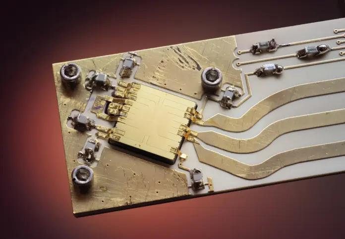 A quantum computer was sold this week, and almost nothing about that sentence is a revenue event. IonQ announced on 22 September that Florida International University has contracted to take a Superion 256 — the first sale and deployment of the 256-qubit trapped-ion platform in Florida — with installation "currently expected in late 2027, following completion of FIU's on-campus data center." No price was disclosed by either party. IonQ closed at $44.98 on 24 September, inside a 52-week range of $25.89 to $84.64, carrying a market capitalisation of $17.09bn against roughly $246m of trailing-twelve-month revenue. That is about 69 times sales for a business whose delivery model looks nothing like the software businesses that usually earn that multiple.
The mismatch is the story. The market is valuing IonQ the way it values a platform company, and IonQ is executing the way a defence prime executes: long-lead, on-premises, milestone-gated, customer-site-dependent, and adjacent to federal funding cycles. The FIU contract makes that explicit in a way no previous announcement has, because the delivery date is governed not by IonQ's manufacturing but by whether a university finishes a building. Having modelled a few capital-equipment order books through their first delivery cycle, that dependency is where the surprises live — and it is invisible in a bookings headline.
The insight: bookings and revenue are fifteen months apart, and the gap is funded by the balance sheet
The arithmetic is straightforward and nobody is running it. In the second quarter of 2026, IonQ recognised $80.05m of revenue and spent $160.63m on research and development — two dollars of R&D for every dollar of revenue. Revenue is growing very fast (up 287% year on year from $20.69m, with first-half revenue of $144.72m against $28.26m), but the company is not remotely funded by it. What funds the gap between a contract signed in 2026 and a system accepted in late 2027 is the $1.236bn of cash and equivalents on the balance sheet at 30 June.
Investors are broadly comfortable with that structure in software, where the gap between a signed contract and delivered service is measured in weeks. It behaves very differently in capital equipment. This is the same distinction FinanceFeeds drew when Oracle disclosed a $664bn remaining performance obligation and <a href="https://financefeeds.com/oracle-q1-fy27-rpo-664-billion-36-month-conversion/">told the market it expects roughly half of it to convert inside 36 months</a>: a backlog is only as good as the conversion schedule attached to it, and the schedule is where the risk sits. It is also the trap behind Palantir's recent move to a 2026 high <a href="https://financefeeds.com/palantir-stock-2026-high-faa-smart-contract-it-lost/">on a contract it had actually lost</a> — contract headlines and contract economics are separate instruments.
Key facts: the FIU Superion 256 contract
IonQ announced a contract with <strong>Florida International University</strong> for a <strong>Superion 256</strong> on <strong>22 September 2026</strong> — the first sale and deployment of the platform in Florida — <a href="https://www.ionq.com/news/ionqs-superion-256-platform-selected-by-florida-international-university-for-flagship-deployment">IonQ, 22 Sep 2026</a>
Installation is <strong>expected in late 2027</strong>, after FIU completes its on-campus data centre; the system will sit in a purpose-built secure facility — IonQ, 22 Sep 2026
<strong>No contract value was disclosed</strong> by IonQ or FIU. A $25m figure circulated on X following the Quantum World Congress; FinanceFeeds could not verify it against either party's disclosures and does not treat it as established
The sixth-generation system carries <strong>256 physical trapped-ion qubits</strong> and will be available to FIU's <strong>55,000 students and more than 1,800 faculty</strong> — IonQ, 22 Sep 2026
Superion 256 launched <strong>8 September 2026</strong>; orders opened immediately with <strong>customer deliveries in 2027</strong>, and IonQ had <strong>pre-sold its first system in Q1 2026</strong> — <a href="https://www.ionq.com/news/ionq-launches-superion-product-line-industry-leading-upgradeable-platform-designed-to-scale-manufacturable-fault-tolerant-quantum-computing">IonQ, 8 Sep 2026</a>
Q2 2026 revenue <strong>$80.05m</strong> (up 287% year on year); first-half revenue <strong>$144.72m</strong>; FY2025 revenue $130.02m — <a href="https://www.sec.gov/cgi-bin/browse-edgar?action=getcompany&CIK=0001824920&type=10-Q">IonQ SEC filings via XBRL company facts</a>
Q2 2026 research and development expense <strong>$160.63m</strong>, roughly <strong>2.0x</strong> quarterly revenue; cash and equivalents <strong>$1.236bn</strong> at 30 June 2026 — IonQ SEC filings
IONQ closed at <strong>$44.98</strong> on 24 September; market capitalisation <strong>$17.09bn</strong>; 52-week range <strong>$25.89–$84.64</strong> — <a href="https://www.nasdaq.com/market-activity/stocks/ionq">Nasdaq, 24 Sep 2026</a>
What IonQ has actually built, and why the manufacturing claim is the important one
Set the contract aside for a moment, because the September product launch contains the more consequential disclosure. IonQ fabricated its first fully integrated 256-qubit processing units at SkyWater, its own subsidiary foundry, after six tapeouts in the first half of 2026. It says the design cycle compressed from nine months to two, and that the teams delivered twelve times more wafer lots over a six-month period than at a previous foundry.
Those are semiconductor metrics, not physics metrics, and that is deliberate. "Superion is the result of two strategic acquisitions coming together to deliver this historic milestone. Oxford Ionics enabled IonQ to control natural, trapped-ion qubits using standard electronics, and SkyWater unlocked the ability to manufacture at semiconductor costs and scale," said Niccolo de Masi, Chairman and CEO of IonQ. "Superion 256 is the first quantum computer platform designed to be built by the hundreds rather than one at a time."
The technical substitution underneath that claim is real: IonQ's Electronic Qubit Control replaces laser systems with electronics integrated on the chip, manufactured with standard semiconductor processes — the same control technology behind its 99.99% two-qubit gate fidelity record set in October 2025. The practical consequence is that a Superion occupies a standard server rack footprint, needs no bespoke building, draws less power than a rack of GPUs, and cools into a normal data-centre environment. IonQ expects the shift from laser-based to semiconductor-based control to cut cost per qubit by more than 300 times across the roadmap.
If that holds, quantum stops being a laboratory installation and becomes a procurement line. Which makes it all the stranger that a university installation still depends on the university building a data centre first.
Market impact: what the FIU deal does and does not tell you
What it tells you is that the commercial pipeline is real and is broadening beyond national laboratories and cloud partners into the university-and-regional-development channel, which in the United States is heavily federally subsidised. FIU's own framing was explicit about that: the university runs a research showcase and briefing centre in Washington, D.C., and President Jeanette M. Nuñez said the partnership "puts the university in a leading position to engage with key federal agencies to advance recently launched quantum initiatives that address many national needs in the areas of sensing, cryptography, commercialization and workforce development." Translated: the machine is a platform for winning federal grants. That is a durable demand channel, and it is also a politically contingent one.
What it does not tell you is price, margin, payment schedule, or acceptance criteria — the four things that determine whether this contract is worth anything to shareholders. With no disclosed value and a delivery date fifteen months out, the announcement is a marketing asset with a revenue tail attached, and the tail lands in a fiscal period most models do not yet contain.
DimensionBull readingBear reading
<strong>The contract</strong>First Florida deployment, flagship academic partner, federal-agency adjacencyNo price, no payment terms, delivery gated by a building IonQ does not control
<strong>Revenue trajectory</strong>Q2 revenue up 287% to $80.05m; first half $144.72m versus $28.26m$246m trailing revenue against a $17.09bn market cap is roughly 69x sales
<strong>Manufacturing</strong>In-house SkyWater foundry, six tapeouts in H1, design cycle cut from nine months to twoZero Superion systems have been installed and accepted anywhere
<strong>Balance sheet</strong>$1.236bn cash funds the order-to-delivery gap without dilution pressureR&D alone ran $160.63m in one quarter, twice revenue; GAAP results swing violently on fair-value items
That last point deserves a flag for anyone reading headline earnings. IonQ's GAAP net result swung from a reported profit of $805.36m in the first quarter of 2026 to a loss of $1.868bn in the second, producing a first-half net loss of $1.062bn. Swings of that magnitude on a company with $145m of half-year revenue are not operating outcomes; they are fair-value remeasurements. Anyone underwriting this equity should be modelling cash burn and backlog conversion, not net income.
The regulatory and strategic tension
Quantum sits in an unusual position: it is simultaneously a subsidised national priority and a controlled technology. The same federal interest that makes a university deployment commercially attractive also brings export licensing, security-clearance requirements for facilities, and end-use restrictions that do not apply to conventional high-performance computing. FIU's system will be housed in a "specialized, secure facility," which is a procurement requirement as much as an engineering one.
Running alongside that is the cryptographic clock. European supervisors have already warned that <a href="https://financefeeds.com/eu-watchdogs-warn-quantum-computing-could-threaten-bitcoin-cryptography/">quantum computing could threaten the cryptography underpinning Bitcoin</a>, and the same logic applies to every settlement system, custody arrangement and messaging network in wholesale finance. That creates a strange dual demand: institutions buy quantum capability partly to understand the threat that quantum capability creates. It is a durable source of budget, and it is one of the few commercial rationales in this sector that does not depend on a fault-tolerant machine arriving on schedule.
On schedule is the operative phrase. Chris Ballance, President of Quantum Computing at IonQ, was specific about the roadmap: "CMOS integration is expected to reach full fault tolerance reality in a 2027 lab setting at IonQ, and manufacturable, commercial reality in 2028." Every valuation argument for this company routes through that sentence.
Three things to watch
<strong>One: the first installed and accepted Superion, not the next order.</strong> IonQ pre-sold a Superion 256 in the first quarter of 2026 and has now announced a second named customer, with deliveries beginning in 2027. Orders are cheap to announce and expensive to fulfil. The disclosure that will move the multiple is an acceptance — a system installed, commissioned and signed off at a customer site — because that is the event that proves the manufacturing claim and converts backlog into recognised revenue.
<strong>Two: the first hard price will come from a procurement record, not from IonQ.</strong> Vendors do not publish list prices while they are establishing average selling prices in a market with two or three credible suppliers. Public universities and federal agencies, however, generate paper. Expect the first verifiable Superion price to surface in a board agenda, a state purchasing filing or a grant award document — and expect it to reframe the sector's revenue models more than any earnings call will.
<strong>Three: 2028 is the number that matters, and slippage compresses the multiple faster than wins expand it.</strong> At roughly 69 times trailing sales, IonQ is priced for the fault-tolerant roadmap, not for the current order book. A single additional university contract adds very little to that; a six-month slip in the CMOS fault-tolerance milestone subtracts a great deal. The asymmetry is unfriendly, which is why the stock sits 47% below its 52-week high despite a year of genuinely strong commercial news. Our <a href="https://financefeeds.com/ionq-stock-price-prediction-75-bull-22-bear/">bull and bear case on IONQ</a> and the comparable <a href="https://financefeeds.com/rigetti-stock-price-prediction-30-bull-8-bear/">analysis on Rigetti</a> set out how wide that distribution currently is.
None of this makes the FIU contract unimportant. Andres G. Gil, FIU's senior vice president for research and economic development, described a machine that will "enable our team to run complex computational workflows" and train "the skilled workforce needed to support Florida's growing quantum industry." Workforce and regional development are how expensive technologies acquire political constituencies, and political constituencies are how they acquire budgets. It is a genuinely good deal for IonQ. It is simply not, yet, a number.
FAQ
<strong>What did IonQ sell to Florida International University?</strong>
A Superion 256, IonQ's sixth-generation quantum computing platform with 256 physical trapped-ion qubits. It is the first sale and deployment of a Superion 256 in Florida. The system will be housed in a purpose-built secure facility on FIU's campus and made available to the university's 55,000 students and more than 1,800 faculty, with research spanning materials science, AI, logistics, cybersecurity, health and power grid management.
<strong>When will the IonQ system be installed?</strong>
Installation is currently expected in late 2027, following completion of FIU's on-campus data centre. The timeline therefore depends on the university's construction schedule as well as IonQ's manufacturing, which is an unusual dependency for a contract being read as a commercial milestone.
<strong>How much does a Superion 256 cost?</strong>
Neither IonQ nor FIU disclosed a contract value. A $25m figure circulated on X after the Quantum World Congress, but FinanceFeeds could not verify it against either party's public disclosures and does not treat it as established. The most likely source of a verifiable price is a public procurement or grant record rather than a company announcement.
<strong>What is IonQ's revenue and valuation?</strong>
IonQ reported $80.05m of revenue in the second quarter of 2026, up 287% year on year, and $144.72m in the first half against $28.26m a year earlier. Trailing-twelve-month revenue is roughly $246m. At a $44.98 close on 24 September and a $17.09bn market capitalisation, that is about 69 times trailing sales.
<strong>Why did IonQ report a $1.87bn quarterly loss?</strong>
Because GAAP results at this company are dominated by fair-value remeasurements rather than operations. IonQ reported net income of $805.36m in the first quarter of 2026 and a net loss of $1.868bn in the second, for a first-half net loss of $1.062bn — swings far larger than the $144.72m of half-year revenue. Cash burn and backlog conversion are the meaningful metrics; net income is not.
<strong>When does IonQ expect fault-tolerant quantum computing?</strong>
Chris Ballance, IonQ's President of Quantum Computing, said CMOS integration is expected to reach "full fault tolerance reality in a 2027 lab setting at IonQ, and manufacturable, commercial reality in 2028." IonQ also expects the move from laser-based to semiconductor-based qubit control to reduce cost per qubit by more than 300 times across its roadmap.