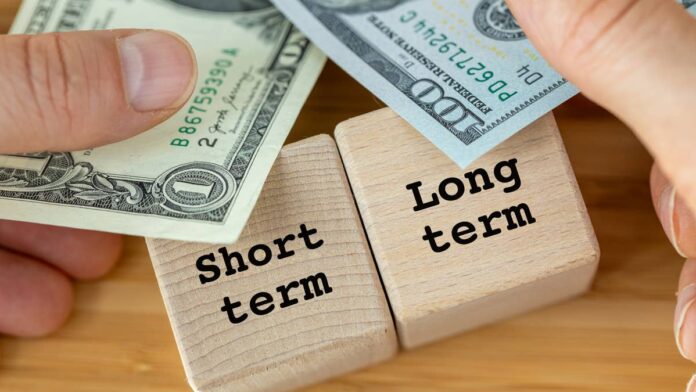 Anyone who has carried a balance on a credit card knows the part of debt that actually hurts. It is not the number you owe. It is the rate attached to it.A $10,000 balance at 3% is a nuisance you manage. The same balance at 20% starts making decisions for you.The federal government runs on that same arithmetic, with more zeros and fewer exits. Washington has spent the past several years borrowing the way a household leans on a low introductory rate, taking the cheap money now and assuming it stays cheap.For a while, the assumption held. Short-term Treasury bills <a href="https://www.thestreet.com/dictionary/y/yield">yield</a> less than 10-year and 30-year bonds, and leaning on them kept the annual interest bill from climbing even faster than it has.That assumption is now under pressure from the one institution the Treasury cannot control.The government is refinancing trillions of dollars every few months, and the <a href="https://www.thestreet.com/dictionary/f/federal-reserve">Federal Reserve</a> under new Chair <a href="https://www.thestreet.com/personalities/kevin-warsh-net-worth">Kevin Warsh</a> has started talking about raising interest rates rather than cutting them.
Treasury Secretary Scott Bessent has funded the deficit with short-term bills as rates turn.<a href="https://www.gettyimages.com/detail/2232888483">Andrzej Rostek / Getty Images</a>
<strong>Why the Treasury leaned so hard on short-term bills</strong>The logic was never complicated. Bills maturing in a year or less cost less to issue than long bonds, and with an annual deficit projected near $2 trillion, cheaper wins the argument every time.About 85% of debt issuance over the past few years has been Treasury bills maturing within a year, according to <a href="https://fortune.com/2026/07/20/us-debt-treasury-short-term-rates-hawkish-fed-rate-hikes/">Fortune</a>, citing research from Capital Economics.<strong>More Economic Analysis</strong>:<a href="https://www.thestreet.com/employment/jpmorgan-ceo-has-a-strong-warning-on-americas-skilled-workforce"><strong>JPMorgan CEO has strong warning on America's skilled workforce</strong></a><a href="https://www.thestreet.com/investing/stocks/nvidias-ceo-doubles-down-on-ai-stock-market-verdict"><strong>Nvidia CEO doubles down on Al and stock market verdict</strong></a><a href="https://www.thestreet.com/investing/stocks/warren-buffett-value-hard-to-find-stock-market-2026"><strong>Warren Buffett pulls no punches on stock market for 2026</strong></a>The consequence is a debt stack that turns over at speed. Roughly 20% of outstanding federal debt comes due in the next four months, and that share reaches 33% within a year.Treasury Secretary <a href="https://www.thestreet.com/personalities/scott-bessent-net-worth">Scott Bessent</a> criticized this approach before he took the job. He has since extended it.The department's most recent refunding statement committed to "maintaining nominal coupon and FRN auction sizes for at least the next several quarters," according to the <a href="https://home.treasury.gov/news/press-releases/sb0489">Treasury Department</a>. An FRN is a floating rate note, a security whose payout resets with short-term rates.The Treasury also has more competition for money than it did a year ago. Hyperscalers are issuing heavy volumes of debt to fund artificial intelligence buildouts, and Germany plans to borrow 800 billion euros by 2030 for defense.More borrowers chasing the same pool of savings means higher yields for everyone drawing on it, including the U.S. government.<strong>What a hawkish Fed does to the debt math</strong>Every dollar of short-term debt is a dollar that gets repriced soon. That is a gift when the Fed is cutting. It is a bill when the Fed is not.A sharp rise in short-dated yields from an unexpected hike is "the biggest risk to the debt burden," wrote Ariane Curtis, senior North America economist at Capital Economics, in a note reported by <a href="https://fortune.com/2026/07/20/us-debt-treasury-short-term-rates-hawkish-fed-rate-hikes/">Fortune</a>.Half of Fed policymakers have penciled in increases, and analysts at Bank of America (<a href="https://www.thestreet.com/quote/BAC">BAC</a>) moved their forecast to three quarter-point hikes this year, up from a base case of no change at all.<strong><a href="https://www.thestreet.com/personal-finance/scott-bessent-pitches-parents-on-trump-accounts-launch">Related: Scott Bessent pitches parents on Trump Accounts launch</a></strong>Cleveland Fed President Beth Hammack said <a href="https://www.thestreet.com/dictionary/i/inflation">inflation</a> is running too high and that the labor market sits "right around my level of maximum employment," according to her <a href="https://www.linkedin.com/feed/update/urn:li:share:7483872290867179521/">LinkedIn post</a>. She added that businesses are now asking her for action on prices, and that consumers describe a growing sense of despair.Warsh has been less explicit and no less pointed. "We have the tools to do it," he told senators during his first appearance on Capitol Hill as chairman, <a href="https://www.thestreet.com/fed/markets-federal-reserve-kevin-warsh-fed-inflation-interest-rate-strategy-congress">TheStreet</a> covered. The backdrop is not helping. The collapse of the U.S.-Iran ceasefire has pushed oil higher again, and the national average for a gallon of gasoline is back above $4.Energy prices feed inflation, inflation feeds a <a href="https://www.thestreet.com/dictionary/h/hawkish">hawkish</a> Fed, and a hawkish Fed feeds the Treasury's refinancing cost. The loop closes on itself.<strong>How the interest bill reaches your household</strong>This is where the abstraction ends.When I mapped the refinancing calendar against the Fed's meeting schedule, the mismatch was the part that stayed with me. A decision made in a single afternoon reprices roughly a third of the national debt inside 12 months. Nobody in Congress votes on that.Here is what the bill already looks like before any hike lands:Net interest on the national debt is projected to total $1.0 trillion in fiscal 2026, according to the <a href="https://www.cbo.gov/publication/62105">Congressional Budget Office</a> (CBO).That works out to roughly $2.8 billion a day, according to the <a href="https://www.pgpf.org/article/any-way-you-look-at-it-interest-costs-on-the-national-debt-will-soon-be-at-an-all-time-high/">Peter G. Peterson Foundation</a>.Interest already costs more than Medicare and more than national defense, according to the <a href="https://www.crfb.org/blogs/net-interest-costs-will-double-again-over-next-decade">Committee for a Responsible Federal Budget</a>.Federal debt held by the public hits 101% of gross domestic product this year, according to the <a href="https://www.cbo.gov/publication/62105">CBO</a>.Interest is not a program anyone campaigns on. It is a fixed charge that clears before Social Security checks and before anything a member of Congress promised you. When it grows, something else gets squeezed.For a portfolio, the transmission is faster. Higher short-dated yields pull money toward cash and money market funds, which have swelled past $7 trillion in assets, according to <a href="https://www.risk.net/our-take/7961339/the-case-for-believing-in-a-bessent-put">Risk.net</a>. Every equity valuation has to beat that number to justify itself.Short-term yields also price the credit you actually touch. Credit card rates and small business lines of credit move with the front end of the curve, not the 30-year bond.<strong>What to watch as the debt path narrows</strong>The bond market is already asking the harder question.Hoisington Investment Management, bullish on Treasuries for more than three decades, turned bearish this month, with its quarterly report noting that investors "increasingly demand a higher risk premium on Treasury securities," according to <a href="https://www.bloomberg.com/news/articles/2026-07-16/hoisington-us-bond-bull-for-decades-turns-decidedly-bearish">Bloomberg</a>.That is a sentence about confidence, not arithmetic. Arithmetic can be refinanced. Confidence cannot.My reading of the setup is that the Treasury has not made a mistake so much as spent its own margin for error. Short bills were the right call when rates were falling. They leave nothing in reserve if rates rise.Two dates matter next. The Federal Open Market Committee (FOMC) meets July 28 and 29, where futures traders put the odds of no change near 90%. The Treasury's next quarterly refunding announcement follows in early August.Watch whether that forward guidance on coupon sizes survives. If the language softens, the Treasury is quietly moving to lock in longer maturities before the window shuts. If it holds, Bessent is doubling down with a hawkish Fed in the room.Neither choice is comfortable. Extending maturities means paying more today for certainty tomorrow. Staying short means a cheaper bill and a wager that the Fed blinks first.One of those bets is wrong, and this particular invoice arrives every quarter.<strong><a href="https://www.thestreet.com/economy/scott-bessent-shares-the-truth-about-american-gold-and-dollars-reserve-investment">Related: Scott Bessent shares the truth about American gold and dollars</a></strong>