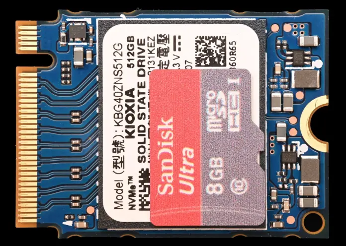 SanDisk did not rise 2,969% because the world suddenly bought more flash memory. It rose because the world paid roughly three times as much for very nearly the same amount of it. That distinction is the whole article, and it is not a matter of interpretation: SanDisk's own annual report says total products sold grew "by mid-teens percent on an exabyte basis" in fiscal 2026, while revenue grew 175%. Shares closed at $1,536.87 on 1 September 2026, against a 52-week low of $50.07 and a high of $2,354.39 — meaning the stock is simultaneously up 2,969% from its floor and down 34.7% from its ceiling. Anyone hunting the next SanDisk is really hunting the next repricing of a capped commodity, not the next great growth company. Those are different screens, and only one of them works.
Here is the part that inverts the usual "picks and shovels" list. SanDisk earned an 84.6% gross margin in its fourth quarter by <em>not building anything</em>. Capital expenditure for the entire fiscal year was $177 million — nine-tenths of one per cent of revenue — because SanDisk does not own its fabs outright. It holds 49.9% of Flash Ventures, the joint venture with Kioxia that operates eight plants in Japan. It physically could not expand into the shortage, so the shortage expanded its margin instead. The screening criterion that actually mattered was therefore <strong>low</strong> capital spending, not high. Every list that goes looking for the company best positioned to build into a boom is looking for the company most likely to end it.
Key facts
SanDisk (SNDK) closed at <strong>$1,536.87</strong> on 1 September 2026 — 2,969% above its 52-week low of $50.07 and 34.7% below its high of $2,354.39 — <a href="https://stockanalysis.com/stocks/sndk/">stockanalysis.com</a>, 1 September 2026
Fiscal 2026 revenue <strong>$20.25 billion, up 175%</strong>; GAAP net income $11.43 billion against a $1.64 billion loss a year earlier — <a href="https://www.sec.gov/Archives/edgar/data/2023554/000162828026053346/sndkq4-26ex991xpressrelease.htm">SanDisk Form 8-K</a>, 5 August 2026
Bits shipped grew only <strong>"mid-teens percent on an exabyte basis"</strong>, while revenue per gigabyte rose roughly 180% in Edge and 150% in Datacenter — <a href="https://www.sec.gov/Archives/edgar/data/2023554/000162828026057406/sndk-20260703.htm">SanDisk Form 10-K</a>, 17 August 2026
Gross margin moved from <strong>26.2% to 84.6%</strong> in four quarters; operating income went from $18 million to $7,037 million — SanDisk Form 8-K, 5 August 2026
Capital spending for the whole year: <strong>$177 million, or 0.9% of revenue</strong> — SanDisk Form 10-K, 17 August 2026
SanDisk holds <strong>49.9% of Flash Ventures</strong>, the Kioxia joint venture running six fabs in Yokkaichi and two in Kitakami — SanDisk Form 10-K, 17 August 2026
Just <strong>146.42 million shares</strong> outstanding, and a forward P/E of <strong>7.18</strong> against a trailing 20.84 — stockanalysis.com, 1 September 2026
What actually happened to SanDisk
SanDisk completed its separation from Western Digital on 21 February 2025 and began life as a standalone Nasdaq company with a carve-out balance sheet, a commodity product and no obvious reason for anyone to own it. In the quarter ended 28 March 2025 it lost money at the operating line, on a 22.5% gross margin. Eighteen months later it reported a quarter with $8.97 billion of revenue and $6.90 billion of net income.
The mechanism is stated plainly in the company's own results release: "Sequential revenue growth came approximately one-third from higher volumes and two-thirds from higher pricing." Break fiscal 2026 down by segment and the picture is starker still. Datacenter revenue rose 437%, but exabytes shipped rose about 120% and revenue per gigabyte rose about 150%. Edge revenue rose 195% on high-single-digit exabyte growth and a roughly 180% increase in revenue per gigabyte. In Consumer, SanDisk shipped <em>fewer</em> bits — volumes fell by a mid-teens percentage — and still booked 29% more revenue, because price per gigabyte rose by a low-fifties percentage.
Now add the cost side. Because NAND costs are set by wafer starts and technology transitions decided quarters earlier, the cost base barely moved while the selling price tripled. Full-year operating expenses actually <em>fell</em> 42%, to $2.08 billion, against $12.39 billion of operating income. That is not a business model improving. That is a fixed cost structure meeting a vertical price line. The same force is visible across the memory complex, where a German DDR5 index reached 486% of its July 2025 baseline last month, as covered in our report on how <a href="https://financefeeds.com/ddr5-prices-are-up-nearly-500-as-hyperscalers-book-2027-supply/">DDR5 prices are up nearly 500% as hyperscalers book 2027 supply</a>.
SanDisk's leadership is careful never to call it a price windfall. "We closed fiscal 2026 with a leading technology portfolio, established datacenter as a key growth pillar, and deepened our customer partnerships," said David Goeckeler, Chairman and Chief Executive Officer of SanDisk, in the 5 August results release. "Our technology and products are well positioned to create value for our customers and generate growing and durable free cash flow." The operative word is <em>durable</em> — and the company's own risk factors describe an industry "subject to declining average selling prices, volatile demand, rapid technological change and industry consolidation." Declining. That is the base case management writes down when lawyers are in the room.
SanDisk against Micron, Western Digital, Seagate and Silicon Motion, 12 months to 1 September 2026, indexed to 100. Silicon Motion — which makes the controllers that sit next to the NAND — managed +199% beside the biggest flash price spike on record. Source: stockanalysis.com daily closes; chart by FinanceFeeds, 2 September 2026.
The industry response — and why it ends the trade
Every participant in this market is now doing the thing that terminates it. SanDisk and Kioxia have signalled roughly $31 billion of Japanese semiconductor investment. Micron has told investors it expects industry supply to begin improving gradually in 2028, and has meanwhile locked in 16 strategic customer agreements covering about 20% of its DRAM volume through 2030, against some $22 billion of expected deposits. China's YMTC has publicly targeted NAND leadership by 2027. Samsung and SK Hynix are converting lines. We looked at the largest of those players in our <a href="https://financefeeds.com/samsung-stock-prediction-380000-won-bull-vs-185000-won-bear/">Samsung stock analysis, ₩380,000 bull versus ₩185,000 bear</a>.
SanDisk's own hedge against the cycle is contractual rather than physical. It has signed ten what it calls New Business Model agreements — long-term customer frameworks that, in the 10-K's words, "enhance the predictability of revenue, profitability and cash flow generation, while reducing exposure to industry cyclicality." Read that sentence as an admission. A company does not build machinery to reduce exposure to cyclicality unless it believes cyclicality is coming. The 10-K also warns, separately, that these same long-term agreements "expose us to certain execution, financial, and market risks, which could be significant" — because a contract that locks in today's extraordinary price is wonderful until it locks in yesterday's.
The demand side is genuinely real, and it is worth being precise about why. Micron has said high-bandwidth memory consumes roughly three times the wafer capacity of DDR5 per gigabyte. Every wafer diverted to HBM for AI accelerators is a wafer not making conventional memory, which is how an AI capital-expenditure boom becomes a shortage in consumer storage. Nvidia's quarter, which we covered when <a href="https://financefeeds.com/nvidia-nvda-q2-fy27-earnings-results/">Nvidia's Q2 revenue hit $96.2 billion but the margin guide sent the stock lower</a>, is the demand signal at the top of that chain. Apacer chief executive C.K. Chang has forecast severe shortages persisting through at least mid-2027.
So: a real shortage, with a dated end. The market appears to agree. SanDisk trades on a forward P/E of 7.18 against a trailing 20.84 — and a single-digit forward multiple on a commodity producer running an 84.6% gross margin is not a bargain signal. It is the textbook signature of peak cyclical earnings, the same shape steel and shipping and fertiliser print at the top. The stock being 34.7% below its high is the market having already started this argument. Retail positioning has followed the volatility rather than the fundamentals, as we noted when <a href="https://financefeeds.com/sndk-stock-perpetual-volume-hits-62-4-of-u-s-spot-turnover-highest-in-available-data/">SNDK perpetual volume hit 62.4% of US spot turnover</a>.
The screen, stated so you can disagree with it
Reverse-engineering SanDisk gives five conditions. I have written them as tests rather than themes, so you can apply them to your own candidates and throw mine out.
<strong>Capacity it cannot expand.</strong> Capital spending below roughly 2% of revenue, or output controlled through a joint venture, a licence or a permit. SanDisk: 0.9%.
<strong>A price lever, not a volume lever.</strong> The product must be fungible and its price set by scarcity, so revenue can triple on flat units. SanDisk: two-thirds of growth from price.
<strong>A depressed margin today.</strong> Operating leverage only exists where there is a thin margin for price to fall through. SanDisk was at a 2.68% operating margin four quarters before it hit 78%.
<strong>A small share count.</strong> 146 million shares for what became a $225 billion company. Scarcity of stock amplifies scarcity of product.
<strong>Structurally under-owned.</strong> A spin-off, a restructuring, an index absence or thin sell-side coverage — something that left the shares in the wrong hands before the move.
Two honest warnings about this screen. First, it is self-defeating by construction: any company that could profit from a shortage by expanding will expand, and thereby end it, which means the ideal candidate is one that is <em>failing</em> to capitalise on its own opportunity. Second, condition five is the one nobody can screen for in advance without hindsight. Applying all five to the US-listed universe of supply-constrained industrials and semiconductor names, five survivors follow. None of them scores five out of five. Saying so is the point.
The five, and what would have to go right
The five names that clear the screen, 12 months to 1 September 2026, indexed to 100. Against SanDisk's +2,799% over the identical window, the best of them managed +101% and one is down 16%. Source: stockanalysis.com daily closes; chart by FinanceFeeds, 2 September 2026.
1. Penguin Solutions (PENG) — $47.59, 52-week range $16.04–$89.86
<strong>Mechanism.</strong> The most direct inheritor of SanDisk's own price. Penguin — the former SMART Global Holdings — builds integrated memory and AI infrastructure, and its capital spending is $10.22 million on $1.50 billion of revenue, or 0.7%. In the quarter reported on 7 July 2026, net sales rose 48% to $479 million while GAAP operating income rose <strong>417%</strong> to $51 million, and GAAP diluted EPS went from a one-cent loss to $0.68. Integrated Memory sales more than doubled. Just seven analysts cover it. "Memory is increasingly becoming one of the primary performance and scalability bottlenecks," said Kash Shaikh, Chief Executive Officer of Penguin Solutions, in the <a href="https://www.sec.gov/Archives/edgar/data/1616533/000161653326000041/pengq3-26form8xkxex991.htm">results release</a>.
<strong>What would have to go right.</strong> It must keep repricing output faster than its own input bill rises, and convert the AI Factory positioning into contracts that outlast the memory spike.
<strong>Disconfirming risk.</strong> It does not own a fab. Its gross margin is 27.9% against SanDisk's 84.6%, because a module integrator buys the very commodity that is inflating. Rising NAND is a cost line as well as a price line, and the company carries $508.7 million of debt against $440.3 million of cash. A pass-through cannot mint an 80% margin, ever.
2. Centrus Energy (LEU) — $168.31, 52-week range $142.13–$464.25
<strong>Mechanism.</strong> Structurally the closest twin on the list. Just 19.95 million shares outstanding, a 19.19 million float, and 29.02% of that float sold short. Its trailing operating margin is <strong>0.11%</strong> — the thinnest possible sliver for price to fall through — and it describes itself as the only publicly traded, proven enricher in the market. It has a $900 million HALEU enrichment award from the US Department of Energy and has grown contingent enrichment backlog to <strong>$3.0 billion</strong>. "We continue to see healthy demand momentum with consistent constrained supply, resulting in upward pressure on SWU prices," said Amir Vexler, President and Chief Executive Officer of Centrus Energy, in the <a href="https://www.sec.gov/Archives/edgar/data/1065059/000162828026053433/ex991-10q2026_08x05.htm">second-quarter release</a>.
<strong>What would have to go right.</strong> The centrifuges have to spin. Centrus expects to complete its first new centrifuge at Oak Ridge by the end of 2026 and is raising hiring in Piketon, Ohio. It has to become a producer rather than a reseller.
<strong>Disconfirming risk.</strong> This is the finding that changed my view of the name. In the June quarter, the average price of separative work units sold rose 3% — while the average unit <em>cost</em> of the SWU sold rose <strong>13%</strong>, and volume fell 23%. Costs are climbing four times faster than prices. That is the exact inverse of the SanDisk pattern, and it is what a reseller's income statement looks like in a shortage. Free cash flow is negative $163.8 million.
3. Powell Industries (POWL) — $172.14, 52-week range $83.85–$328.00
<strong>Mechanism.</strong> The purest capital-discipline match. Powell builds switchgear and electrical distribution equipment for data centres, LNG and utilities, and spends $12.16 million of capex on $1.16 billion of revenue — 1.0%, almost exactly SanDisk's ratio. It carries $633.6 million of cash against <strong>$2.52 million of total debt</strong>. In the quarter ended 30 June 2026 it booked $934 million of new orders, up 158%, for a book-to-bill of 3.0x, and backlog reached $2.4 billion, up 69% year on year. "Commercial momentum across our key end markets continues to accelerate," said Brett A. Cope, Chairman and Chief Executive Officer, in the <a href="https://www.sec.gov/Archives/edgar/data/80420/000008042026000103/ex991-powlq3xfy2026earning.htm">3 August release</a>, citing a data-centre order worth over $400 million.
<strong>What would have to go right.</strong> Gross margin has to break out of the 30% band it has sat in for years. The backlog proves demand; only pricing proves scarcity.
<strong>Disconfirming risk.</strong> Revenue grew 9% while orders grew 158%. Powell is capacity-constrained — but management characterises the environment as "strong and stable pricing", and stable is precisely what you do not want. Worse, custom-engineered equipment is sold on fixed-price contracts, so a shortage in copper, steel or components raises Powell's input costs against revenue already locked in. The same constraint that made SanDisk rich can make an engineering contractor poor.
4. Photronics (PLAB) — $27.33, 52-week range $20.05–$56.00
<strong>Mechanism.</strong> The valuation match, and the thinnest coverage on the list at three analysts. Photomasks are a genuine oligopoly — Photronics, Dai Nippon and Toppan — and every chip made needs them. It trades at 1.24 times book with an enterprise value of $942.6 million against a $1.61 billion market capitalisation, because $672.8 million of the market cap is net cash. This is roughly where SanDisk's story began: cheap, ignored, structurally important.
<strong>What would have to go right.</strong> A mask shortage would have to actually arrive, and Photronics would have to price for it rather than absorb it.
<strong>Disconfirming risk.</strong> There is no evidence any of that is happening. Quarterly revenue for the last five quarters ran $210m, $216m, $225m, $210m, $216m — flat. Gross margin held between 31% and 35%; operating margin between 20% and 24%. Nothing is moving. And its forward P/E of 13.32 sits <em>above</em> its trailing 9.67, meaning consensus expects earnings to fall. Most damning against the screen: Photronics spends $198 million of capex on $867 million of revenue — 22.8%. It builds. Companies that build never get scarce.
5. Amkor Technology (AMKR) — $45.73, 52-week range $23.36–$96.68
<strong>Mechanism.</strong> The strongest bottleneck and the worst share arithmetic — included precisely because that trade-off is what the screen exists to expose. Advanced packaging is the hardest physical constraint in AI compute after high-bandwidth memory, and Amkor is the largest US-listed outsourced assembly and test provider. Its 15.5% gross margin means enormous leverage: revenue rose 26% year on year in the June quarter, and net income rose <strong>219%</strong>, from $54.4 million to $173.8 million. Only 108.7 million of its 248.5 million shares are in free float.
<strong>What would have to go right.</strong> Packaging capacity would have to stay tight for several more years while Amkor's newer plants ramp into already-sold demand.
<strong>Disconfirming risk.</strong> Amkor fails the first and most important test outright. It is spending <strong>$1.37 billion a year in capex — 18.4% of revenue — to end the very shortage it would profit from</strong>, and free cash flow is negative $172.4 million as a result. Set that against SanDisk's $177 million on a revenue base nearly three times larger. Same shortage; opposite capital behaviour; and the gross margins, 15.5% against 84.6%, tell you which behaviour the market pays for.
How the five score against the screen
TestPENGLEUPOWLPLABAMKR
Capex under ~2% of revenueYes (0.7%)No (23%)Yes (1.0%)No (22.8%)No (18.4%)
Price lever currently firingYesPartly (+3%)No (flat)NoYes
Depressed margin to leverYes (8.2%)Yes (0.1%)No (19.7%)No (22.5%)Yes (8.6%)
Small share countYes (51m)Yes (20m)Yes (36m)Partly (59m)No (248m)
Under-ownedYes (7 analysts)PartlyPartlyYes (3 analysts)Partly
<strong>Score</strong><strong>4.5/5</strong><strong>3/5</strong><strong>2.5/5</strong><strong>1.5/5</strong><strong>2.5/5</strong>
SanDisk scored five out of five in September 2025. Nothing available today does. That gap is the honest answer to the question in the headline.
Policy is now the supply curve
The tension running underneath all of this is that governments have become the marginal supplier in exactly the industries this screen selects. That cuts both ways, and it is why the regulatory layer cannot be treated as background.
In enrichment, the constrained supply Centrus describes is a policy artefact: the US ban on Russian low-enriched uranium removed a large share of Western supply, and the Department of Energy is now both Centrus's regulator and, through the $900 million HALEU award, its largest customer. A shortage created by statute can be relieved by statute. In semiconductors, export controls have simultaneously restricted Chinese access to advanced tooling and given YMTC a state-backed mandate to reach NAND leadership by 2027 — subsidised capacity that answers to industrial policy rather than to price signals. Subsidised capacity is the natural enemy of a margin like SanDisk's, because it keeps arriving after the return on it has vanished.
The same logic applies to the roughly $31 billion of Japanese investment signalled by SanDisk and Kioxia and to CHIPS-supported packaging build-outs of the kind Amkor is undertaking in Arizona. Each is rational for the firm and corrosive to the pricing that justified it. For anyone applying this screen, the practical instruction is narrow: check whether a candidate's scarcity is protected by physics and capital intensity, which take years to overcome, or merely by a rule, which can change at the speed of an election. Photronics' oligopoly is the former. Centrus's is substantially the latter.
What happens next
Three concrete expectations, with the reasoning attached.
<strong>First, SanDisk's margin peaks before its revenue does.</strong> Guidance for the September quarter is $10.30–10.80 billion of revenue with gross margin of 83.0–85.0% — flat to marginally down on the 84.6% just delivered, on 15% more revenue. The last increment of pricing power has already been taken. Because the cost base resets with each technology transition and each new wafer agreement, cost of goods will start catching up to price from the following quarter, and the compression will show in gross margin before it shows in the top line.
<strong>Second, the correct trade from here is a second-derivative trade, not another SanDisk.</strong> The odds of a 30-fold move being available in a widely watched complex, twelve months into the shortage that caused the last one, are very poor. The five names above are all between 47% and 64% below their own 52-week highs; SanDisk is 34.7% below its. You are being invited to find a 30-bagger during a drawdown in the very sector that produced the last one.
<strong>Third, the next SanDisk will not be in memory.</strong> The condition that made the trade — an owner of capped capacity that cannot expand — is now being dismantled everywhere in flash by the $31 billion of announced Japanese investment and by YMTC. It will reappear in a different constrained input, most plausibly one where the constraint is a permit, a licence or a qualification cycle rather than a factory. That is the case for keeping enrichment and grid equipment on the list despite their weak scorecards: their bottlenecks are administrative and physical, not merely financial, and those take far longer to clear.
Having read the fiscal 2026 10-K line by line, the sentence that stays with me is not in the results release at all. It is the risk factor describing an industry "subject to declining average selling prices." SanDisk wrote that in August 2026, in the same document that reported an 84.6% gross margin. Both statements are true. Only one of them is about the future.
Frequently asked questions
<strong>Why did SanDisk stock rise 2,969%?</strong>
Almost entirely on price rather than volume. SanDisk's fiscal 2026 accounts show bits shipped grew by a mid-teens percentage while revenue grew 175%, with revenue per gigabyte up roughly 180% in Edge and 150% in Datacenter. Because its costs were fixed by earlier wafer decisions, gross margin went from 26.2% to 84.6% in four quarters, and profit rose far faster than sales.
<strong>Was SanDisk's run a supply shock or a durable earnings story?</strong>
Predominantly a supply shock. The company itself attributes about two-thirds of its sequential growth to pricing. A durable story would show rising unit volumes and reinvestment; SanDisk shipped only mid-teens percentage growth in bits and spent 0.9% of revenue on capital projects. Its long-term customer agreements are an attempt to convert some of the shock into durability, which is a genuine effort but not the same thing.
<strong>What is the screen for finding the next SanDisk?</strong>
Five tests: capacity the company cannot quickly expand (capital spending under roughly 2% of revenue); a fungible product whose price is set by scarcity; a currently depressed operating margin for that price to fall through; a small share count; and shares that are structurally under-owned after a spin-off, restructuring or thin analyst coverage.
<strong>Why is a low P/E a warning sign for a stock like this?</strong>
Because commodity producers look cheapest at the top of the cycle, when peak earnings are divided into a price the market has already begun to discount. SanDisk's forward P/E of 7.18 against a trailing 20.84 reflects consensus expecting the current run-rate to persist — but a single-digit multiple on an 84.6% gross margin in a commodity is the classic shape of peak cyclical earnings, not of a bargain.
<strong>Which of the five best fits the SanDisk mechanism?</strong>
On the tests above, Penguin Solutions scores highest at 4.5 out of 5, largely on capital discipline, operating leverage and thin coverage. But it does not own a fab, so its gross margin of 27.9% caps how far the mechanism can carry it. Centrus Energy has the best structure — 20 million shares, a 0.11% operating margin — and currently the worst economics, with unit costs rising 13% against 3% price growth.
<strong>Is the memory shortage expected to end?</strong>
The dates are on the record. Micron has said it expects industry supply to begin improving gradually in 2028, and Apacer chief executive C.K. Chang has forecast severe shortages persisting through at least mid-2027. SanDisk and Kioxia have signalled roughly $31 billion of Japanese investment, and China's YMTC has targeted NAND leadership by 2027.
<em>This article is analysis and information only. It is not investment advice, nor a recommendation to buy, sell or hold any security. Prices, ranges and financial data are as of the close on 1 September 2026 and will change. Figures are drawn from company filings with the US Securities and Exchange Commission and from stockanalysis.com; readers should verify current data and consider their own circumstances before making any financial decision.</em>