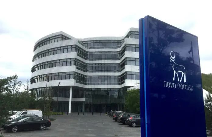 Novo Nordisk raised its full-year outlook twice in 2026 and the stock is down 28% from its January peak. That combination is the whole investment case, in either direction. On 4 August the shares fell 6% on 47.5 million ADRs, the heaviest volume of the past year, and the headline everywhere was that the Wegovy pill had missed sales estimates. It had - by about 100 million Danish kroner, roughly $15 million on a 3.2 billion kroner line. A 3% shortfall on one product in one quarter did not erase $12 billion of market value.
What did was a number almost nobody put in a headline. Goldman Sachs analyst James Quigley cut his peak sales forecast for CagriSema, Novo's next-generation obesity candidate, from $11.8 billion to $5 billion - a $6.8 billion revenue line removed from the model, which took roughly 6% off his topline and 10% off his operating profit estimates across 2026 through 2030, and prompted a downgrade to Neutral. Having watched a fair number of pharma selloffs get attributed to the wrong line item, this is a clean example: the market repriced a pipeline, not a quarter, and the commentary chased the smaller number because it was the one in the earnings release.
Key facts
<strong>ADR price:</strong> $45.97 close on 6 August 2026, up 3.23% on the day after a two-stage decline; 28.1% below the 26 January peak of $63.98 - <a href="https://www.nasdaq.com/market-activity/stocks/nvo">Nasdaq, 6 Aug 2026</a>
<strong>The two shocks:</strong> 31 July -8.8% on a late-stage heart-drug trial miss, then 4 August -6.0% on 47.5 million ADRs, the year's heaviest volume - <a href="https://www.nasdaq.com/market-activity/stocks/nvo">Nasdaq historical data, Aug 2026</a>
<strong>CagriSema downgrade:</strong> Goldman cut peak sales from $11.8 billion to $5 billion, trimming operating profit estimates ~10% for 2026-2030 - <a href="https://www.tikr.com/blog/novo-nordisk-nyse-nvo-stock-hits-52-week-low-as-goldman-sachs-downgrades-it-to-neutral">Goldman Sachs via TIKR, Aug 2026</a>
<strong>Wegovy pill:</strong> Q2 sales of 3.2 billion kroner (about $500 million) against a 3.3 billion kroner FactSet consensus - <a href="https://www.cnbc.com/2026/08/05/novo-nordisk-stock-guidance-earnings-wegovy-ozempic-eli-lilly.html">CNBC, 5 Aug 2026</a>
<strong>Prescription velocity:</strong> the first million pill prescriptions took 11 weeks without competition; the most recent million took four weeks with it, on 5 million cumulative - <a href="https://www.cnbc.com/2026/08/05/novo-nordisk-stock-guidance-earnings-wegovy-ozempic-eli-lilly.html">CNBC, 5 Aug 2026</a>
<strong>Earnings:</strong> quarterly EPS of $1.02, $1.00, $1.04 and $0.96 - a beat in each of the last four quarters - against forward consensus of $0.79 and $0.82 - <a href="https://www.nasdaq.com/market-activity/stocks/nvo/earnings">Nasdaq consensus and actuals, Aug 2026</a>
<strong>Street target:</strong> consensus $47.23 across 14 analysts, revised down 0.67% over three months, against a $45.97 close - <a href="https://stockanalysis.com/stocks/nvo/forecast/">S&P Global via StockAnalysis, Aug 2026</a>
<strong>Market capitalisation:</strong> $208.4 billion; 52-week ADR range $35.12 to $64.16 - <a href="https://www.nasdaq.com/market-activity/stocks/nvo">Nasdaq, 7 Aug 2026</a>
NVO daily closes over the last twelve months, with the four largest single-day drops marked and the bull and bear targets discussed below. Source: Nasdaq historical data.
A mega-cap trading like a biotech
Here is the statistic that frames everything else. In the last twelve months, a $208 billion pharmaceutical company has had <em>four separate single-day drops of 8% or more</em>: -14.6% on 3 February, -16.4% on 23 February, -8.8% on 31 July and -6.0% on 4 August. Blue-chip pharma does not trade like this. That is a binary-event volatility profile, the kind you expect from a clinical-stage biotech with one asset in Phase 3, not from the company that built the GLP-1 category.
The reason is that Novo's valuation now rests on pipeline outcomes rather than on the installed base. Ozempic and Wegovy are established, and their economics are increasingly well understood. What is not settled is whether Novo has a credible answer to Eli Lilly in the next generation. Every readout that speaks to that question moves the stock by a year's worth of normal volatility in a single session.
February set the pattern: the shares sank 16% when CagriSema failed to match Lilly's tirzepatide in a head-to-head trial in Type 2 diabetes patients. July and August repeated it, first on the heart-drug trial and then on the combination of the Q2 print and further mixed CagriSema data. The market has learned to treat each Novo readout as a referendum on the company's post-semaglutide future, and it is pricing accordingly.
The multiple that moves the wrong way
Novo's earnings arithmetic runs in the opposite direction to most large-cap stories, and it is worth setting out because it is where the bear case actually lives.
Trailing four-quarter EPS is $4.02, made up of $1.02, $1.00, $1.04 and $0.96. At $45.97 that is about 11.4x trailing - cheap for a pharma franchise of this quality. But consensus for the next two quarters is $0.79 and $0.82, both below every quarter Novo has just delivered. Annualise that and forward EPS lands near $3.20, which puts the stock at roughly 14.4x forward.
Read that again: the multiple <em>expands</em> as you move forward, because the earnings are expected to shrink. You are paying more per dollar of profit for a smaller stream of it. That is the mathematical signature of a business the market believes has passed its earnings peak, and it is the exact inverse of the setup we described in our <a href="https://financefeeds.com/micron-mu-stock-prediction-1550-bull-520-bear/">Micron MU stock prediction</a>, where a collapsing forward multiple signals expected earnings decay from a much higher base.
The second tell is the analyst distribution. Novo has beaten consensus in all four of the last quarters, and over the same three months the average price target has been <em>cut</em> by 0.67% to $47.23. Beats are no longer moving targets, because the debate has moved off the income statement entirely. A consensus target 2.7% above the traded price is not a forecast of upside; it is a statement that the sell side has no view worth expressing.
What management is actually arguing
Chief executive Mike Doustdar spent the days after the print pushing back on the pill narrative specifically, and his argument is more substantive than the usual post-selloff reassurance.
The core of it is a profitability claim. "We would not be able to show a positive growth on the top and the bottom if items like the pill were not doing well and were not profitable," Doustdar told <a href="https://www.cnbc.com/2026/08/05/novo-nordisk-stock-guidance-earnings-wegovy-ozempic-eli-lilly.html">CNBC</a>, describing the oral franchise's margins as decent and improving. That matters because the bear reading of the pill is that Novo is buying share by undercutting its own injectable on price - dilutive volume rather than accretive growth.
The supporting data point is the one the market ignored. Novo has passed five million pill prescriptions since launch. The first million took eleven weeks, achieved with no direct competition. The most recent million took four weeks, achieved <em>under</em> competitive pressure. Prescription velocity has therefore roughly tripled at the same time the competitive environment got harder - which is difficult to reconcile with a product that is failing.
Doustdar has also gone further on where this ends: "I could see a future where actually this market is, to a large extent, a pill market," he said, while noting the launch is only six months old. He has separately said he has no doubt about an eventual share price recovery and has signalled an intent to accelerate R&D to close the perceived gap with Lilly. Whether that acceleration is credible is the single question a Novo investor is really underwriting.
The Lilly problem
No honest assessment of Novo works without stating the competitive position plainly, because the divide between the two companies widened again on these results.
Lilly's tirzepatide beat CagriSema head-to-head on glycaemic control in February, and Lilly's most recent quarter reinforced its lead. This is the structural issue: Novo created the obesity category and is now, on the current evidence, the second-best-positioned company in it. For a stock that spent years priced as the franchise owner, moving to challenger status is a re-rating event independent of any single quarter's revenue.
The counter-argument is one of market size rather than share. The obesity market is large enough, and supply-constrained enough, that second place can still compound for years - particularly if the oral formulation genuinely shifts the delivery mechanism. An injectable duopoly and a pill market are different competitive games, and Novo is further ahead in the second. Readers weighing the adjacent listed exposure to this theme may find our <a href="https://financefeeds.com/hims-stock-40-bull-case-21-bear-case/">HIMS stock bull and bear case</a> useful, since its economics turn on GLP-1 access rather than on who wins the molecule race.
The bull case: $64
The bull target is $64, implying roughly 39% upside from $45.97. It is not an invented number: it is approximately the 26 January closing peak of $63.98, a level this stock held six months ago. Two supports.
First, the valuation is undemanding on delivered earnings. At $64 and $4.02 of trailing EPS, the multiple is 15.9x - an ordinary large-pharma rating, not an expansion to anything heroic. The bull case does not need a re-rating premium. It needs the market to stop assuming earnings decline.
Second, the pill has to be judged on velocity rather than on a single quarter's consensus comparison. Tripling prescription pace while under competitive attack is the strongest operating datapoint in the release, and if that trajectory holds for two more quarters the $0.79 and $0.82 forward estimates will prove too low. Novo raising guidance twice in a year that included two trial setbacks is consistent with a base business performing better than the share price implies.
The bull case, in one sentence: CagriSema is a pipeline disappointment rather than a franchise failure, and the market has confused the two.
The bear case: $32
The bear target is $32, roughly 30% below the 6 August close and about 9% below the existing 52-week low of $35.12. Two derivations converge.
The first is normalised earnings. If the forward consensus trajectory continues and 2027 EPS settles near $3.05 as pricing pressure compounds, a 10.5x multiple - the kind applied to pharma facing competitive erosion rather than growth - produces about $32. Note that this requires no catastrophe, only that the existing downward estimate trend persists for another year.
The second is the Goldman revision taken at face value. Removing $6.8 billion of CagriSema peak revenue and 10% of operating profit through 2030 mechanically lowers any discounted valuation by a similar order. Apply that to a stock already at 11.4x trailing and the low-$30s is where the arithmetic lands.
The specific risk to watch is price, not volume. The Wegovy pill is winning share partly by undercutting Novo's own injectable, so a mix shift toward the cheaper oral product can grow prescriptions and shrink revenue per patient simultaneously. That is precisely how a company posts record prescription counts and falling EPS in the same year - and the forward consensus already embeds some of it.
Bull versus bear at a glance
FactorBull case ($64)Bear case ($32)
Wegovy pill1m scripts in 4 weeks vs 11 weeks at launchShare won by undercutting its own injectable
CagriSemaA pipeline miss, not a franchise failure$6.8bn of peak revenue removed from models
Earnings trendFour straight beats; guidance raised twiceForward consensus below every recent quarter
Valuation11.4x trailing is undemanding for pharma14.4x forward - the multiple expands as EPS falls
vs Eli LillyCategory is big enough for a strong secondLost the head-to-head; now the challenger
Analyst viewConsensus still rated Buy$47.23 target is 2.7% away - no conviction either way
What happens next
Three calls, with the reasoning attached.
<strong>The Q3 print matters less than the next CagriSema readout.</strong> Consensus at $0.79 is set below the last four delivered quarters, so a beat is likely and largely irrelevant - the last four beats moved nothing. The stock is a pipeline instrument now, and the four 8%-plus drops of the past year were all triggered by trial data or pipeline revisions, never by a revenue line.
<strong>Watch revenue per prescription, not prescription count.</strong> This is the single ratio that separates the two cases. If pill volumes rise while revenue per script falls, the bear thesis of self-cannibalisation is confirmed regardless of how impressive the headline prescription numbers look. If both hold, Doustdar's profitability argument is validated and the forward estimates are too low.
<strong>Expect the target-price cluster to break rather than drift.</strong> A $47.23 consensus against a $45.97 price is an unstable equilibrium that reflects analysts declining to take a side. Pipeline stocks do not resolve gradually; the next material readout will force a cluster of revisions in one direction. That argues for sizing around event risk rather than around valuation.
Our read: the market punished the wrong number in August, but it reached a defensible conclusion anyway. The pill data is genuinely better than its reception, and the CagriSema write-down is genuinely worse than the coverage implied. Those roughly offset, which is why we regard neither $64 nor $32 as the base case and treat this as an event-driven holding rather than a valuation one. For a comparison of how a similarly binary, catalyst-dependent name is priced, see our <a href="https://financefeeds.com/honeywell-aerospace-hona-stock-prediction-250-bull-118-bear/">Honeywell Aerospace HONA stock prediction</a>, and for the semiconductor version of the peak-earnings debate, our <a href="https://financefeeds.com/texas-instruments-txn-price-prediction-405-bull-vs-225-bear/">Texas Instruments TXN price prediction</a>.
Frequently asked questions
Why did Novo Nordisk stock fall in August 2026?
NVO fell in two stages: 8.8% on 31 July after a late-stage heart-drug trial missed its key efficacy goal, then 6.0% on 4 August on the heaviest volume of the year. The 4 August move followed Q2 results in which the Wegovy pill missed consensus by about 100 million kroner and CagriSema produced further mixed data, prompting Goldman Sachs to cut the drug's peak sales forecast from $11.8 billion to $5 billion and downgrade the stock to Neutral. Shares recovered 3.23% on 6 August.
What is the NVO price target for 2026?
The consensus is $47.23 across 14 analysts, only 2.7% above the 6 August close of $45.97, and that average has been revised down 0.67% over the past three months. Nasdaq lists a one-year target of $46.50. Our bull case is $64 and our bear case is $32.
Is Novo Nordisk stock cheap right now?
On trailing earnings, yes: $4.02 of EPS over the last four quarters puts the ADR at about 11.4x. On forward earnings it is less clear, because consensus of $0.79 and $0.82 for the next two quarters implies roughly $3.20 annualised, or 14.4x. The multiple expands going forward because earnings are expected to fall, which is generally a signal that the market believes the peak has passed.
What happened with CagriSema?
CagriSema is Novo's next-generation obesity candidate. In February 2026 it failed to match Eli Lilly's tirzepatide on glycaemic control in a head-to-head trial in Type 2 diabetes patients, sending the shares down 16.4% in a single session. Further mixed data accompanied the Q2 2026 results, after which Goldman Sachs reduced its peak sales estimate from $11.8 billion to $5 billion and trimmed operating profit forecasts by roughly 10% for 2026 through 2030.
Is the Wegovy pill actually failing?
The evidence is mixed and the headline framing was harsh. Q2 sales of 3.2 billion kroner missed a 3.3 billion kroner consensus, a shortfall of about $15 million. But cumulative prescriptions have passed five million, and the pace has accelerated sharply: the first million took eleven weeks without competition, the most recent million took four weeks with it. CEO Mike Doustdar has described the pill's profitability as decent and improving.
How does Novo Nordisk compare with Eli Lilly?
Lilly currently holds the stronger position. Its tirzepatide won the February head-to-head against CagriSema, and its most recent quarter widened the performance gap. Novo created the GLP-1 obesity category but is now competing as the challenger in the injectable market. Its clearest relative advantage is in oral formulation, where the Wegovy pill has a lead that Doustdar argues could eventually reshape the market toward pills.
<em>This article is for information purposes only and does not constitute investment advice. Price data is as of the 6 August 2026 close and pre-market trading on 7 August 2026.</em>