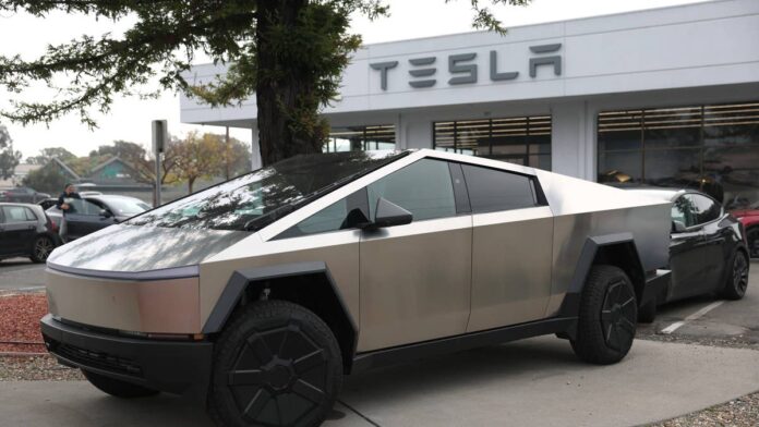 Tesla has spent months pushing employees to use artificial intelligence as aggressively as possible. The company was tracking which engineers consumed the most compute, running internal promotions, and encouraging staff to experiment freely with <a href="https://www.thestreet.com/tag/artificial-intelligence">AI</a> tools. Leadership sent company-wide emails urging workers to try new platforms.Starting July 6, Tesla is capping each employee's spending on third-party AI tools at $200 per week, with anything above that requiring manager approval, according to an internal memo first reported by <a href="https://www.theinformation.com/articles/tesla-caps-employee-ai-spend-200-per-week-adoption-push">The Information</a>. Some engineers had been running up thousands of dollars in weekly token bills.<strong>Why Tesla reversed course on employee AI spending</strong>Over the past six months, Tesla leadership worked to consolidate employee AI usage onto a company-wide platform with approved models and security policies. Teams built leaderboards ranking staff by token consumption. Musk himself sent a company-wide email encouraging engineers to try Composer, xAI's coding tool. Heavy usage was the goal, and some teams took that seriously enough to compete over the metric.When usage-based billing makes the cost of every prompt visible at the individual level, the math changes fast. Some Tesla software engineers were consuming thousands of dollars' worth of tokens in a single week. That is the kind of number that gets flagged in a finance review quickly. Management decided the spending needed a ceiling.<strong>More Tesla:</strong><a href="https://www.thestreet.com/automotive/tesla-faces-texas-crash-lawsuit"><strong>Tesla faces lawsuit from family of victim killed in Texas home crash</strong></a><a href="https://www.thestreet.com/investing/why-a-fatal-crash-threatens-teslas-stock"><strong>Why a fatal crash threatens Tesla’s stock</strong></a><a href="https://www.thestreet.com/investing/stocks/tesla-stock-has-a-spacex-problem-veteran-analyst-says"><strong>Tesla stock has a SpaceX problem, veteran analyst says</strong></a>The timing matters. Musk has staked Tesla's long-term valuation on deploying AI at scale across its Robotaxi network and Optimus humanoid robot. Tesla's revenue has mostly stalled over the past two years, which puts the AI story under more pressure than most investors appreciate.<strong>The Grok exemption and what it says about Tesla's AI strategy</strong>The cap does not apply to beta versions of xAI products, including Grok and Composer, xAI's coding tool. Engineers who run compute-heavy sessions on Claude will burn through their $200 weekly allowance quickly, while Grok and Composer carry no budget counter.The problem is that Grok has not won over Tesla's engineering staff. Four people familiar with internal usage told <a href="https://electrek.co/2026/07/02/tesla-caps-employee-ai-spending-200-week/">Electrek</a> that employees broadly prefer Anthropic's Claude for day-to-day development work. The preference held even through a sustained internal promotion campaign that included personal sessions from xAI product leads.Grok's track record inside Tesla has been bumpy. Electrek reported last year that Tesla's Grok in-car integration failed to interface with the vehicle's own functions: the chatbot could not talk to the car it was embedded in. Musk acknowledged in March 2026 that xAI "was not built right first time around" and that the company was being rebuilt from scratch. That admission came six weeks after Tesla had committed $2 billion of shareholder capital to the venture.The spending policy may not change which tools engineers actually reach for. A financial penalty on Claude still leaves Grok needing to win on performance, and so far it has not done that either.
The spending policy may not change which tools engineers actually reach forSullivan/Getty Images
<strong>Tesla is cutting individual AI spending while tripling corporate AI investment</strong>The $200 cap is easy to misread. At the same time Tesla is limiting individual employee spending, the company has dramatically increased its corporate-level AI investment. Tesla raised its 2026 capital expenditure guidance to over $25 billion, nearly tripling the prior year's allocation, <a href="https://seekingalpha.com/news/4611500-tesla-limits-employee-ai-spending">Seeking Alpha noted</a>. The money is being directed toward computing infrastructure, robotics, and autonomous driving.Tesla still wants AI at the center of the business. The cap redirects spending rather than cutting it: away from engineers running up bills on third-party tools and toward the infrastructure bets that actually touch the product.<a href="https://www.thestreet.com/tag/spacex">SpaceX</a>, meanwhile, is reportedly preparing to acquire Cursor's parent company Anysphere in a deal valued at roughly $60 billion, which would fold one of the most widely used AI coding tools directly into the broader Musk ecosystem. If that deal closes, Tesla engineers who reach for Cursor would effectively be using a Musk-owned product. That deal is separate from Tesla's employee cap, but it adds context to the direction Musk is steering the AI stack across his companies: inward, not outward.<strong>Tesla is not the only company clamping down on employee AI costs</strong>The Uber comparison is the most direct. Ube<a href="https://www.thestreet.com/markets/uber-ceo-coo-sends-a-stark-message-on-ai-spending-in-2026">r</a> had encouraged employees to use AI without restrictions, then burned through its entire 2026 AI budget by April and <a href="https://www.thestreet.com/markets/uber-ceo-coo-sends-a-stark-message-on-ai-spending-in-2026">responded</a> with a $1,500 monthly cap per tool per employee. <a href="https://www.thestreet.com/technology/microsoft-ceo-sends-shocking-message-to-employees">Microsoft canceled Claude Code</a> licenses across its Experiences and Devices division partly due to cost. Meta, Amazon, Walmart, and Coinbase have all introduced similar limits or directed staff toward lower-cost models.The era some in the industry have started calling "tokenmaxxing," meaning indiscriminate burning of AI tokens to create an appearance of productivity, appears to be giving way to a phase of active cost metering. On July 1, <a href="https://www.thestreet.com/quote/PLTR">Palantir</a> CEO <a href="https://www.thestreet.com/personalities/alex-karp-net-worth">Alex Karp</a> appeared on <a href="https://www.cnbc.com/2026/07/01/palantir-karp-open-ai-anthropic-tokens.html">CNBC's Squawk Box</a> and argued that the token economics underpinning the AI industry have broken down as costs have spiraled.For Tesla, a $200 weekly cap is a small number against the company's overall scale. But the speed of the <a href="https://www.thestreet.com/dictionary/r/reversal">reversal</a> tells investors something useful: the AI spending picture can shift very fast, even inside companies most publicly committed to the technology.<strong><a href="https://www.thestreet.com/technology/amazon-joins-microsoft-in-sending-shocking-message-to-employees">Related: Amazon joins Microsoft in sending shocking message to employees</a></strong>