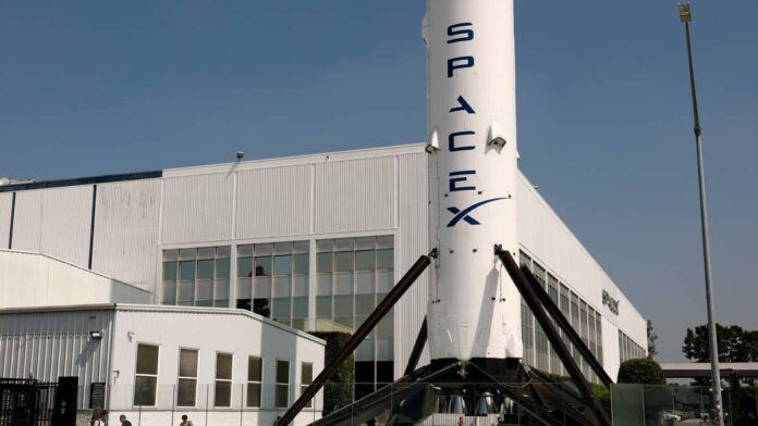 Elon Musk has a habit of answering the biggest questions about his companies without actually answering them. He was asked directly at the All-In Summit why Tesla and SpaceX still operate as two separate companies. He gave an answer that sounded like a riddle but landed like a signal.
The comment reignited a debate that has been building on Wall Street, where analysts, prediction markets and even Musk’s own business partners increasingly treat a Tesla-SpaceX combination as a matter of <em>when</em> rather than <em>if.</em>
<strong>Elon Musk’s latest comments hint at a possible merger</strong>
Speaking at the All-In Summit in Los Angeles on September 14, Musk was asked why the two companies remain separate given how closely they already work together. He called it a great question, then added: “With all this collaboration, on so many levels, who can imagine what action one might take when there’s so much close collaboration in so many areas,”<a href="https://finance.yahoo.com/markets/stocks/article/musk-hints-again-at-possible-spacex-tesla-merger-135029754.html"> according to Yahoo Finance.</a>
At the same event, Musk also addressed the merger question more directly when pressed further. “Obviously, you know, we can’t talk about combining companies on an earnings call. It’s got to be done with the appropriate process,”<a href="https://finance.yahoo.com/markets/stocks/article/musk-hints-again-at-possible-spacex-tesla-merger-135029754.html"> he said.</a> A comment that itself followed reports he had discussed a merger with close colleagues ahead of SpaceX’s June IPO.
<strong>SpaceX:</strong>
<a href="https://www.thestreet.com/investing/stocks/morgan-stanley-doubles-down-on-spacex-stock-for-investors-bull-case"><strong>Morgan Stanley doubles down on SpaceX stock for investors</strong></a>
<a href="https://www.thestreet.com/investing/stocks/spacex-analyst-plots-path-to-100-million-in-recurring-revenue"><strong>SpaceX analyst plots path to bold $100 billion claim</strong></a>
<a href="https://www.thestreet.com/investing/stocks/jpmorgan-raises-spacex-price-target-after-earnings-starlink-elon-musk"><strong>JPMorgan resets SpaceX price target after earnings</strong></a>
SpaceX President Gwynne Shotwell, who joined Musk on stage, reinforced the sense that the companies are moving closer together in practice even without a formal deal. She said SpaceX personnel had already moved into xAI to fill leadership and engineering gaps, describing the businesses as integrating “faster than I thought,” though “not fully integrated yet,”<a href="https://stocktwits.com/news-articles/markets/equity/tesla-spacex-elon-musk-merger-speculation-hints-action-close-collaboration/cZtnRwSRBTo"> Stocktwits reported.</a>
Musk’s comments moved markets. Tesla and SpaceX shares each fell about 2% on September 14 before edging slightly higher in overnight trading, with TSLA recovering 0.2% and SPCX adding 0.1%,<a href="https://stocktwits.com/news-articles/markets/equity/tesla-spacex-elon-musk-merger-speculation-hints-action-close-collaboration/cZtnRwSRBTo"> Stocktwits reported.</a>
<strong>Terafab is the biggest piece of the puzzle</strong>
If there is one project that explains why merger speculation keeps resurfacing, it is Terafab. The joint chip manufacturing venture between Tesla, SpaceX and xAI was confirmed in early 2026, with SpaceX announcing groundbreaking on the Grimes County, Texas facility in August. Musk has described a facility aimed at producing more than one terawatt of AI compute hardware capacity a year,<a href="https://techcrunch.com/2026/08/06/tesla-and-spacex-will-invest-16-8b-to-start-building-terafab-chip-factory-in-texas/"> TechCrunch reported.</a>
The ambition has only grown since then. Intel joined the project as an outside foundry customer, with Musk confirming Terafab will use Intel’s forthcoming 14A manufacturing process. He said the full-scale facility could eventually produce 100 billion to 200 billion custom AI and memory chips annually.
The price tag has climbed just as fast. SpaceX disclosed in a May filing that the first phase of the facility alone would cost $55 billion, with the full buildout potentially reaching $119 billion. ARK Invest has since floated an even larger long-term estimate of $1 trillion in total investment across the project’s life,<a href="https://www.thestreet.com/investing/stocks/elon-musk-sends-a-strong-message-to-tesla-and-spacex-investors"> TheStreet reported.</a>
The stakes for Tesla specifically are significant. The company is counting on Terafab to reduce its reliance on outside chip suppliers like TSMC and Samsung, with the custom silicon meant to power its self-driving systems, Cybercab robotaxis and Optimus humanoid robots.
SpaceX President Gwynne Shotwell, who joined Musk on stage, reinforced the sense that the companies are moving closer together in practice even without a formal deal.<a href="https://www.gettyimages.com/detail/2289079202">Justin Sullivan / Getty Images</a>
<strong>Wall Street is split on whether a deal happens</strong>
Not every analyst agrees on timing, but several now treat a merger as increasingly likely. Wedbush’s Dan Ives has put the odds of a Tesla-SpaceX combination at 80% to 90%, telling Schwab Network he expects a deal to take shape in the first half of 2027. SpaceX’s IPO would also make a stock-based combination more straightforward,<a href="https://www.thestreet.com/investing/dan-ives-spills-the-beans-on-spacex-future"> TheStreet reported.</a>
Jefferies has gone further than most in modeling what a deal could look like, estimating Musk could retain roughly 55.3% voting control in a combination structured as a nil-premium transaction. A framework that would still leave room for Tesla shareholders to receive value.
JPMorgan has taken a more cautious but still directionally similar view, calling a tie-up strategically coherent on paper given the overlapping ambitions in artificial intelligence, robotics, energy, transportation and space that already connect the two companies.
Not everyone is convinced a merger would help investors. BNP Paribas maintained an underperform rating on Tesla, warning that SpaceX’s own cash burn could delay a potential combination and that shareholders hoping for a quick premium may be waiting longer than they expect.
<strong>What it means for Tesla and SpaceX investors</strong>
The financial ties between the two companies are already deep enough to matter regardless of whether a formal merger ever happens. Tesla holds an equity stake in SpaceX that traces back to its $2 billion investment in xAI, which converted to SpaceX equity after SpaceX absorbed the AI company, representing less than 1% of SpaceX. A relationship that has already appeared in regulatory filings through commercial and other agreements,<a href="https://www.thestreet.com/investing/stocks/elon-musk-tesla-and-spacex-face-serious-questions-from-investors-earning-call"> according to TheStreet.</a>
There is a near-term product event that could reinforce the collaboration narrative regardless of merger talk. Tesla’s second-generation Roadster is confirmed to debut on October 1, and Musk has hinted that the production version may incorporate SpaceX thruster technology.
For now, investors are left where they have been for months, parsing Musk’s carefully worded non-answers for clues rather than getting a clear commitment. Until Musk or either company’s board says otherwise, the safest assumption remains that deeper collaboration, not necessarily a formal merger, is the only thing guaranteed to keep happening.
<strong><a href="https://www.thestreet.com/investing/stocks/morgan-stanley-sends-a-blunt-message-to-investors-on-spacex-elon-musk-starlink-potential-generational-compounder">Related: Morgan Stanley sends blunt SpaceX message to investors</a></strong>